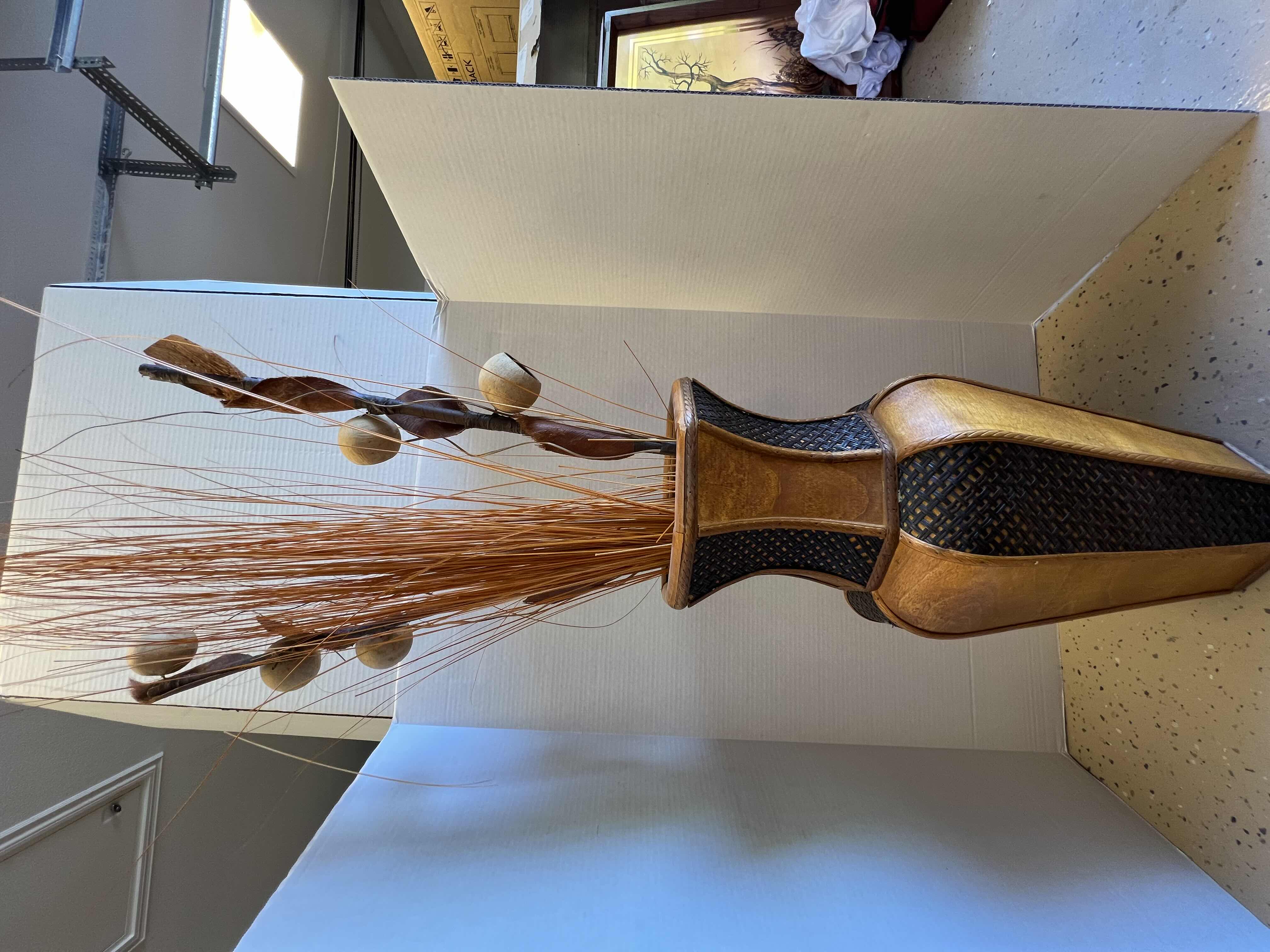 Photo 1 of DECORATIVE ORANGE-BROWN WOODEN VASE. WITH FAUX REEDS AND PLANTS. 10” WICKER AND WOOD DETAILING. 1 OF 2 IN SET. SOLD SEPARATELY