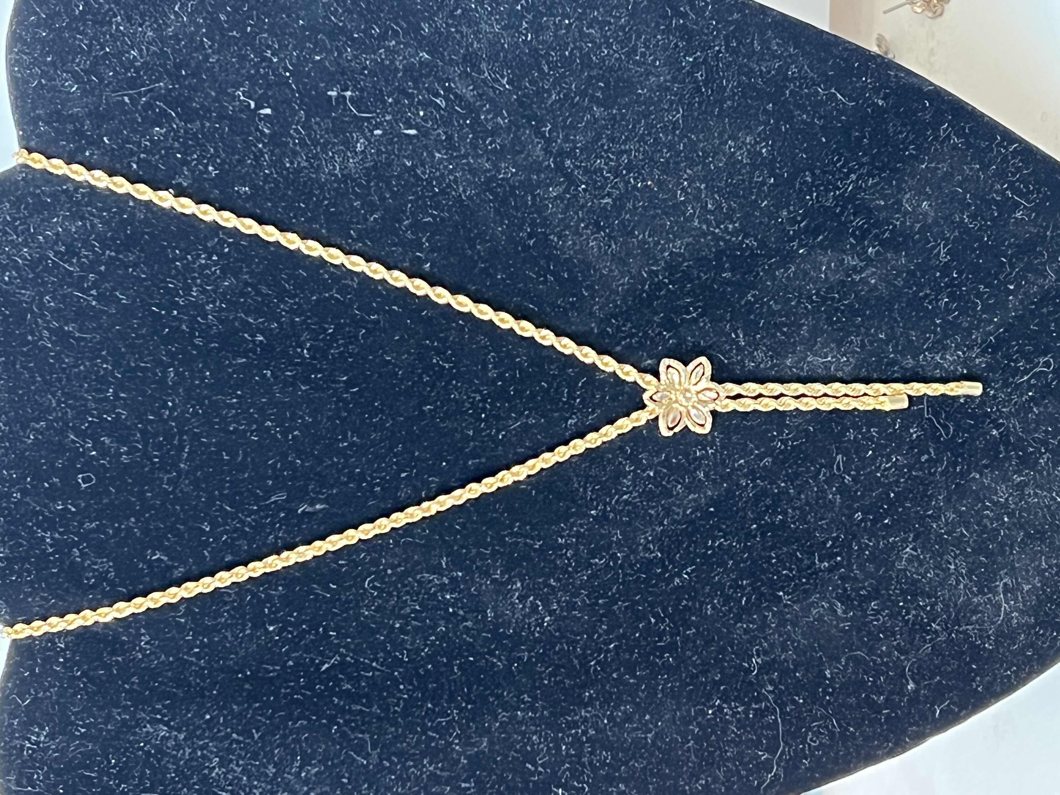 Photo 1 of 14K SMALL GOLD FLOWER NECKLACE. BOLO TIE STYLE.