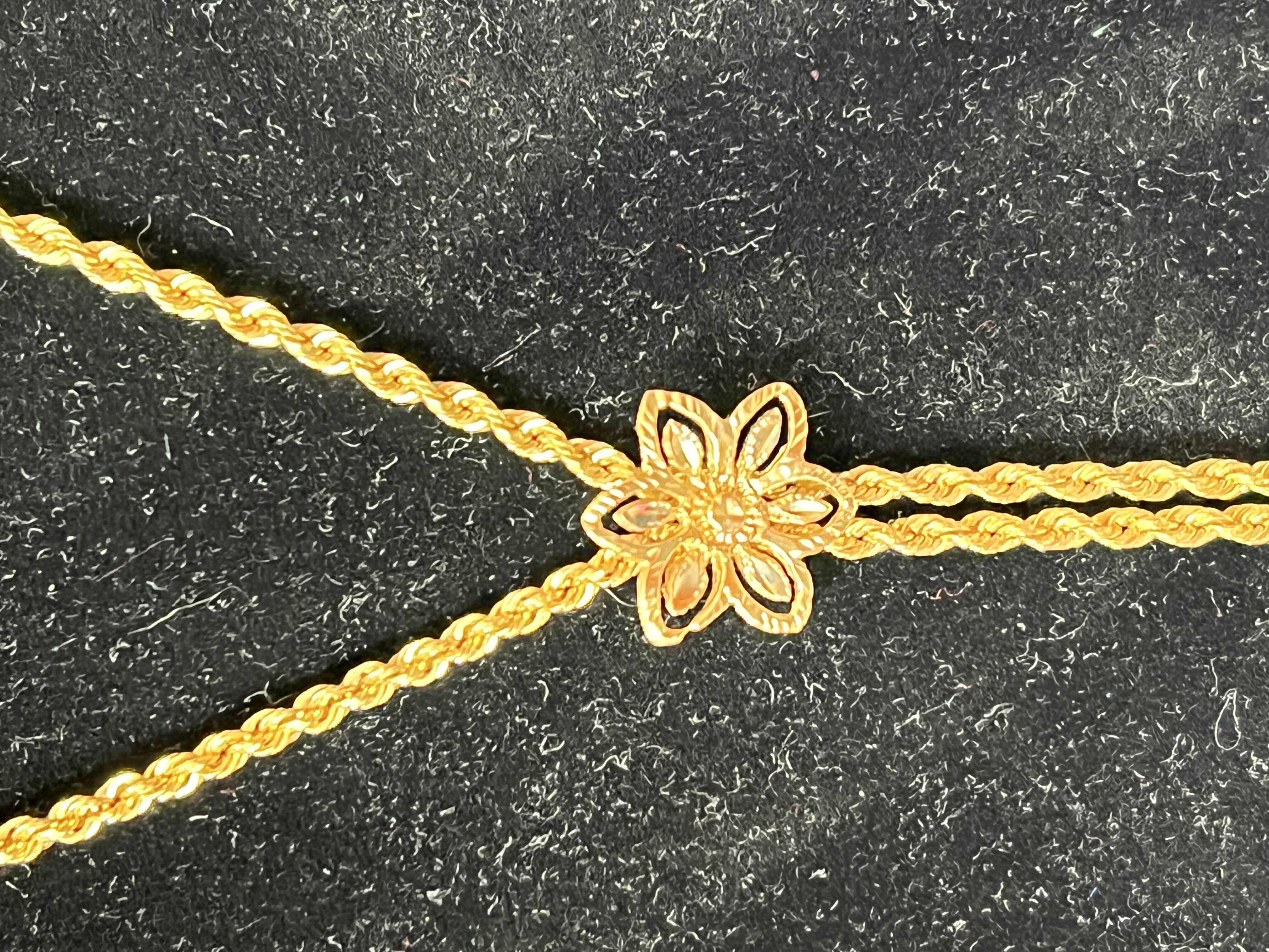 Photo 1 of 14K SMALL GOLD FLOWER NECKLACE. BOLO TIE STYLE.