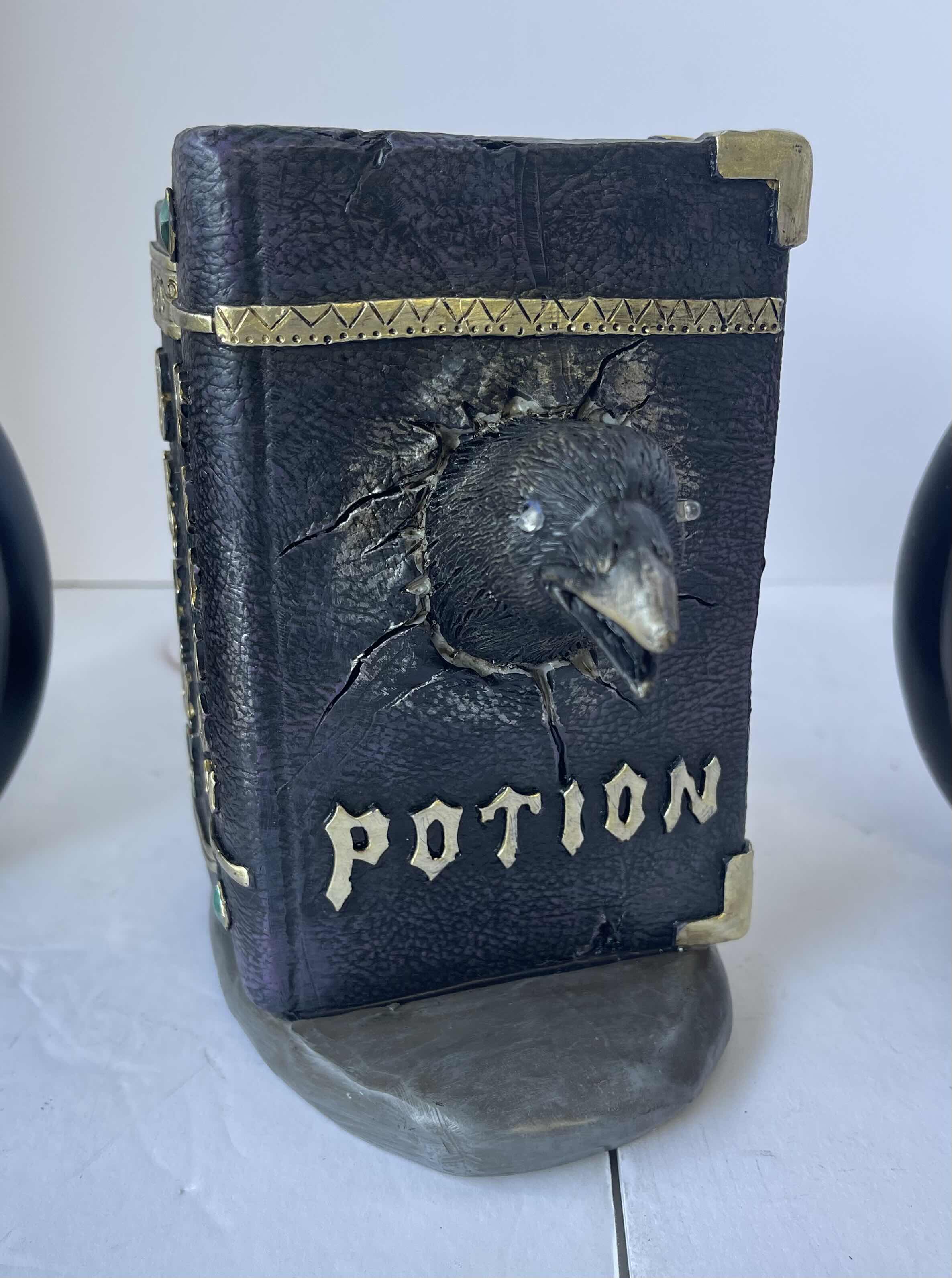 Photo 1 of HAPPY HALLOWEEN 7” TABLE TOP RESIN HOME DECOR - HOCUS POCUS PUMPKINS (3) & LIGHT UP BLACK BIRD IN POTION BOOK (1) NEW