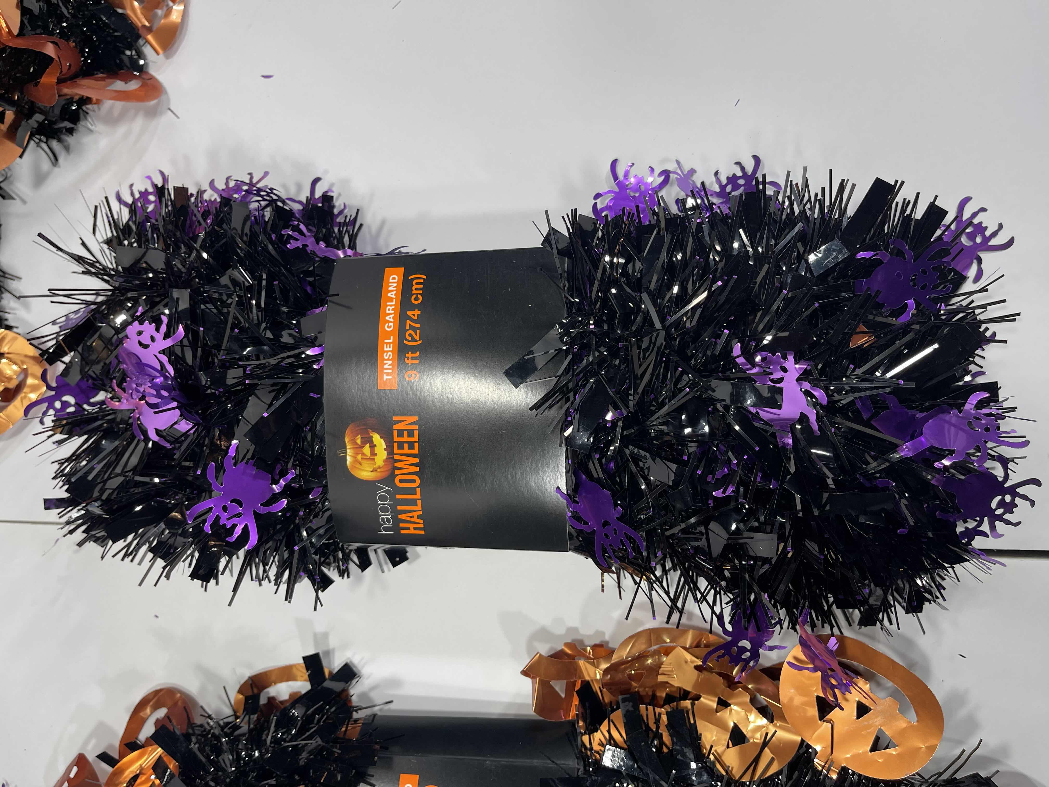 Photo 1 of HALLOWEEN TINSEL GARLAND - BLACK WITH PURPLE SPIDERS 9’ (5) & BLACK WITH ORANGE PUMPKINS 9’ (5) MSRP $80