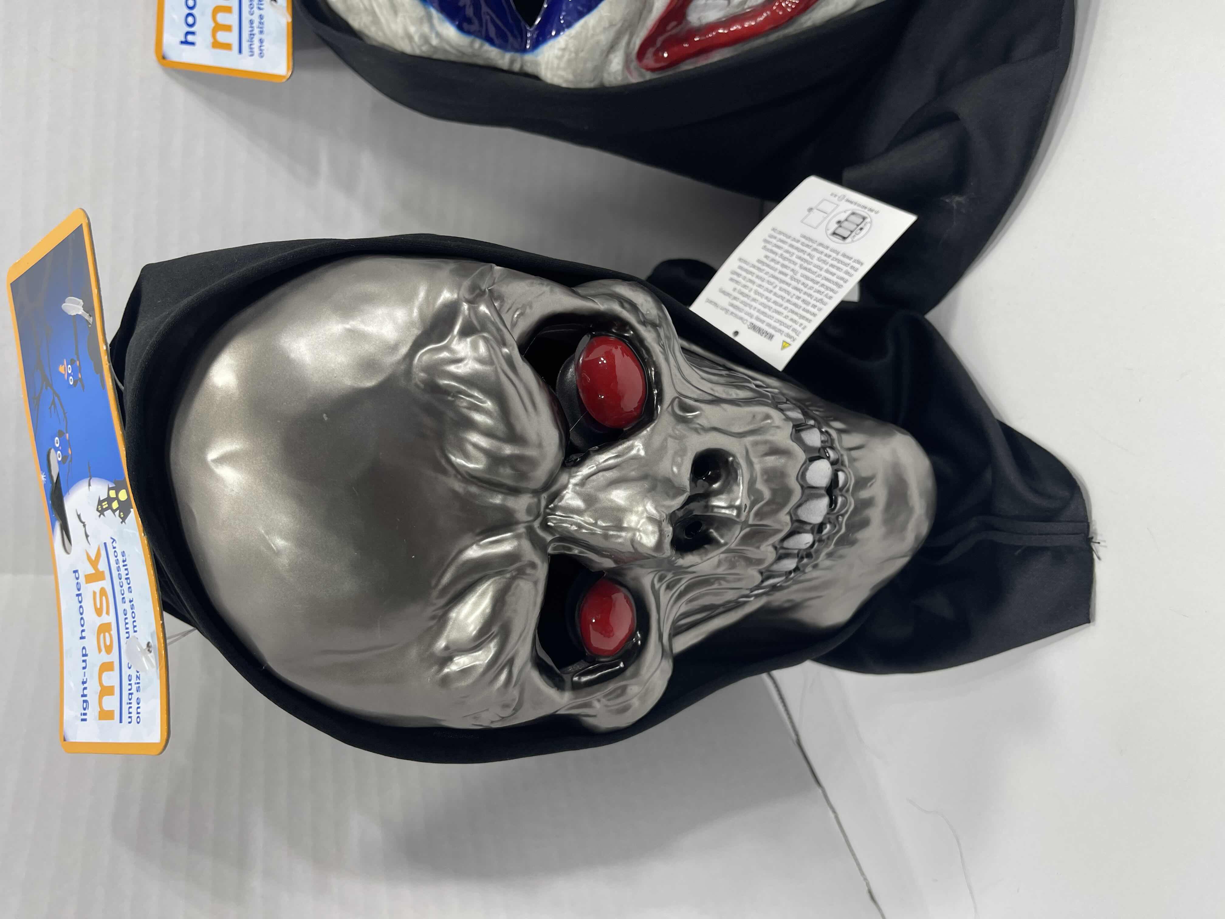 Photo 1 of ADULT ONE SIZE FITS MOST HALLOWEEN PLASTIC HOODED MASKS (3) - TWO MASKS WITH LIGHT UP EYES MSRP $60