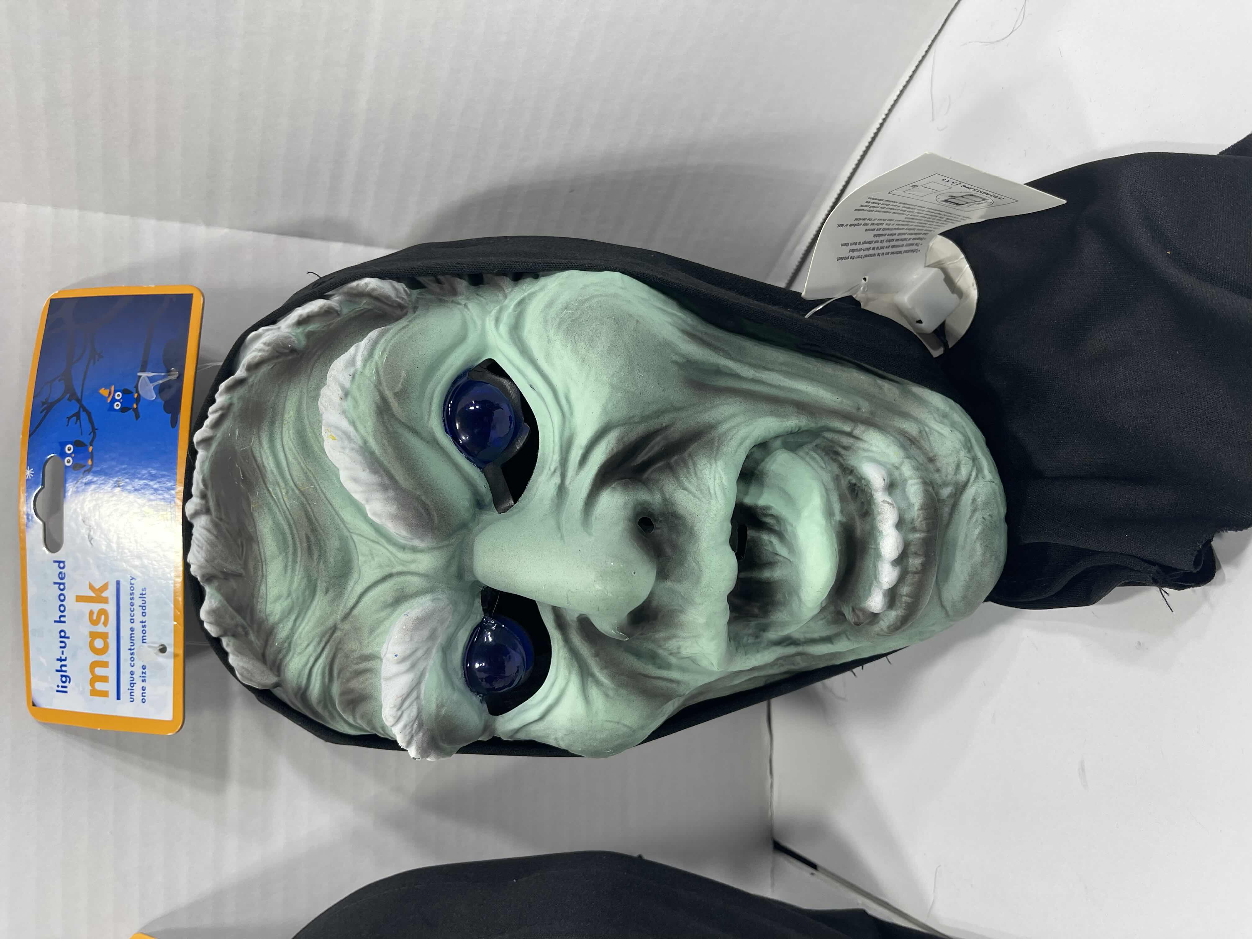 Photo 1 of ADULT ONE SIZE FITS MOST HALLOWEEN PLASTIC HOODED MASKS (3) - TWO MASKS WITH LIGHT UP EYES MSRP $60