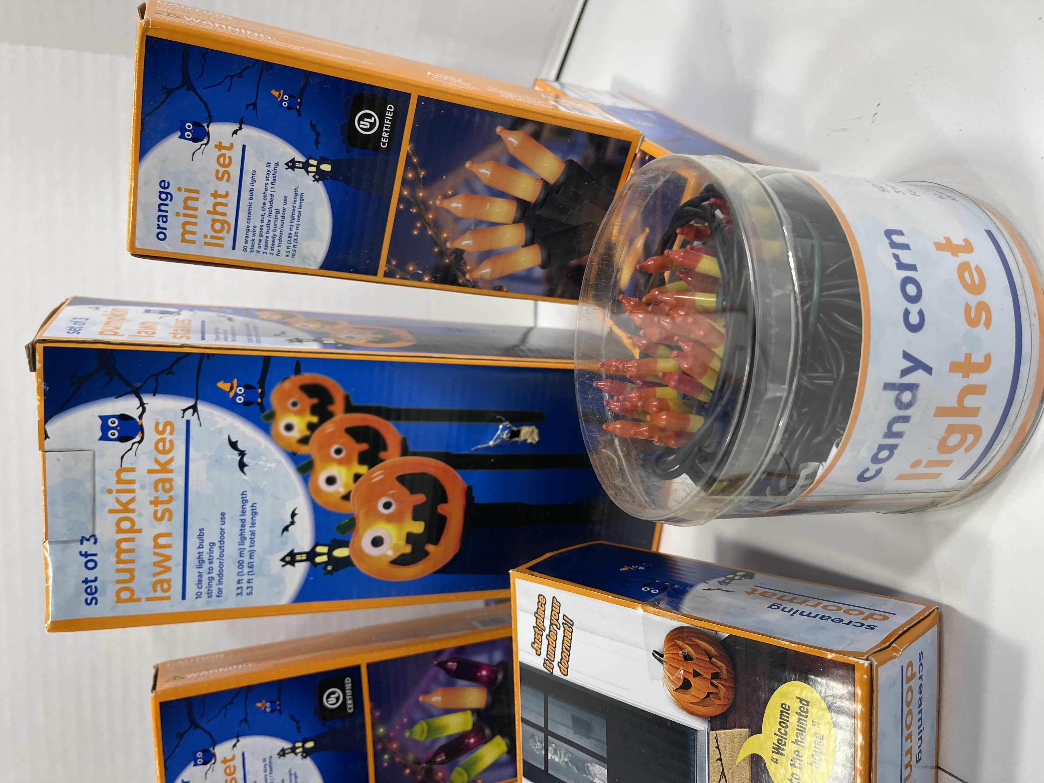 Photo 1 of HALLOWEEN INDOOR/OUTDOOR LIGHT LOT AND SCREAMING DOORMAT - CANDY CORN LIGHTS (2), MINI LIGHT SETS (6), PUMPKIN LAWN STAKES (2 BOXES) MSRP $75
