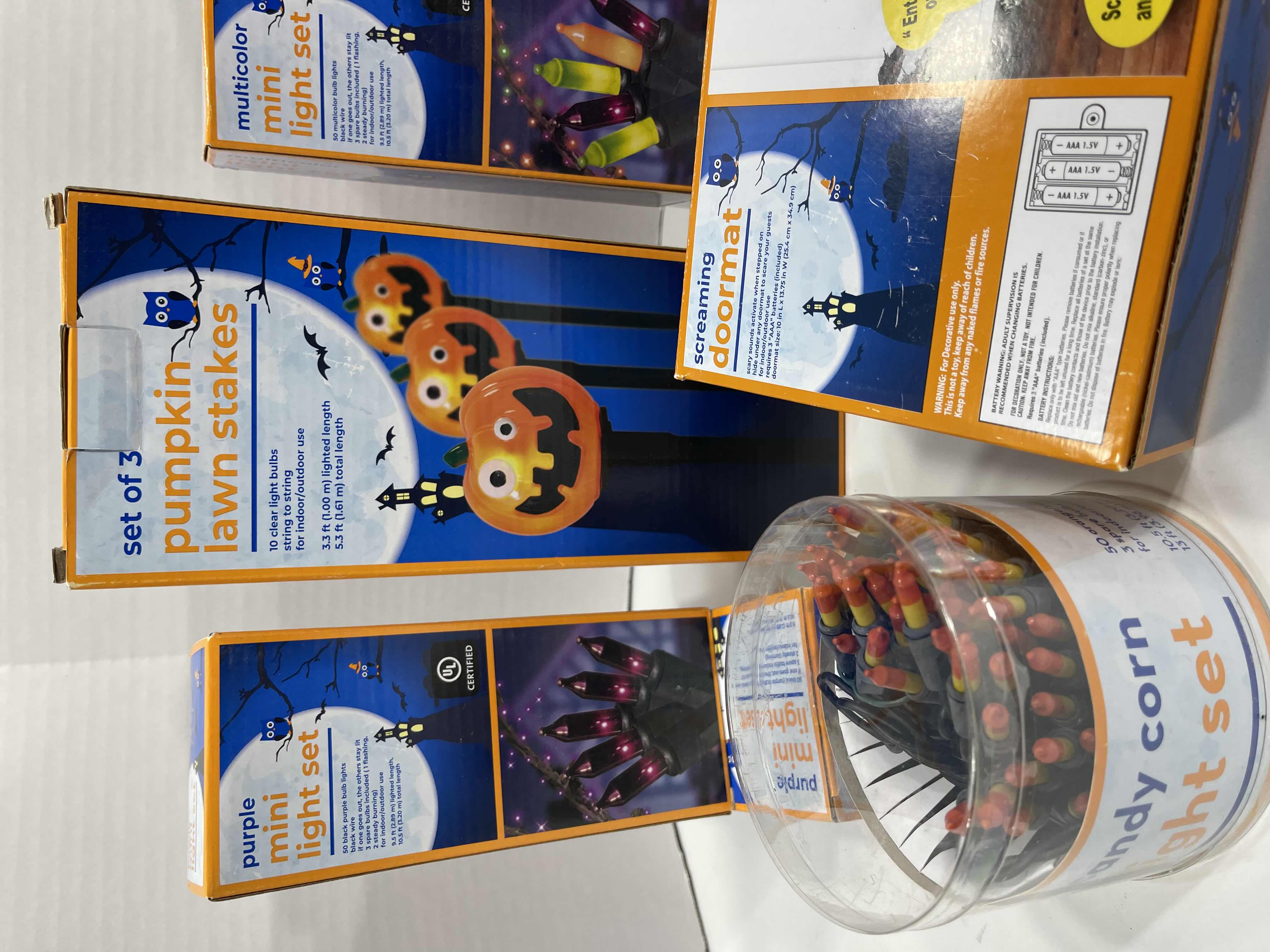 Photo 1 of HALLOWEEN INDOOR/OUTDOOR LIGHT LOT AND SCREAMING DOORMAT - CANDY CORN LIGHTS (2), MINI LIGHT SETS (6), PUMPKIN LAWN STAKES (2 BOXES) MSRP $75