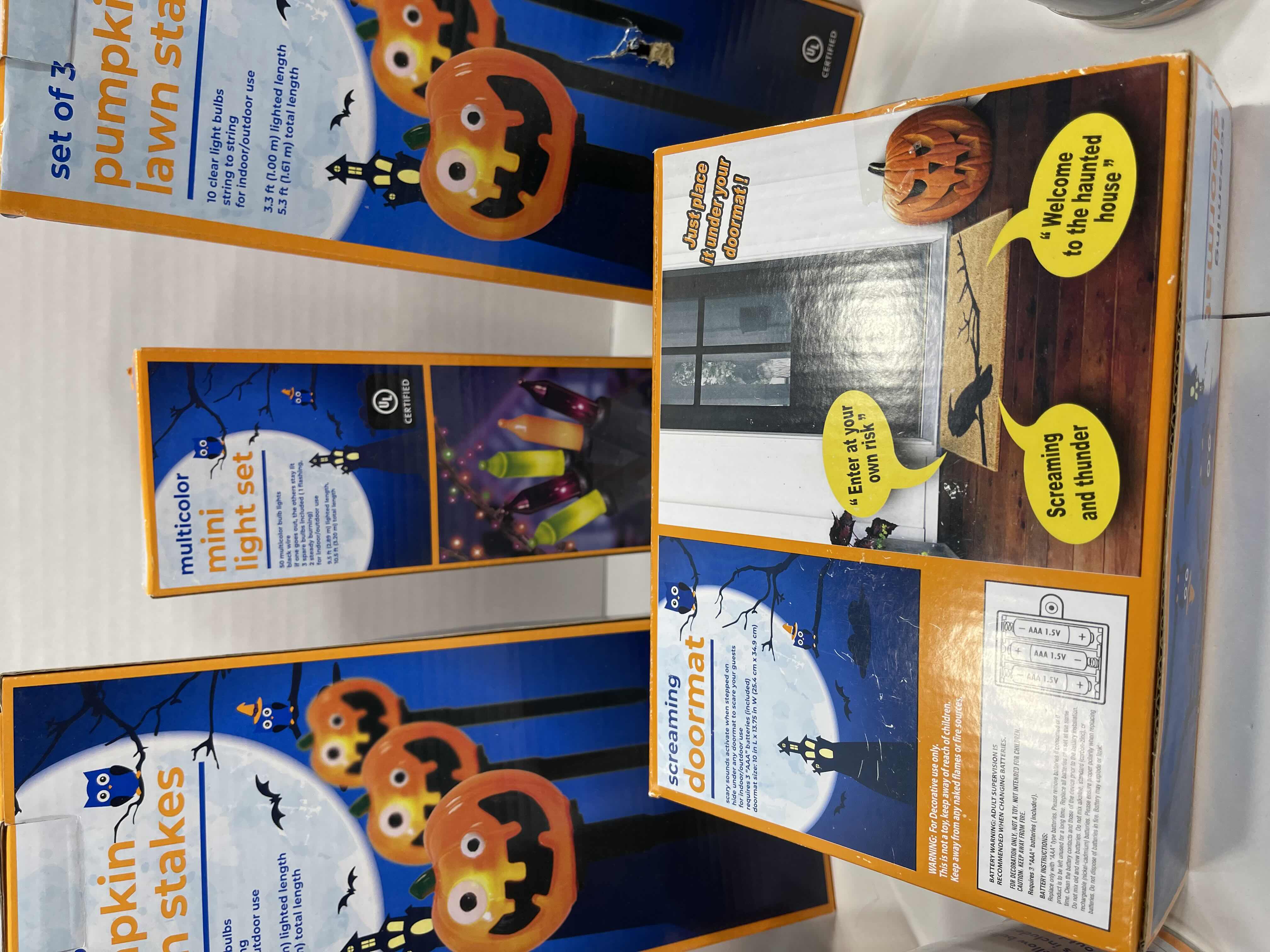 Photo 1 of HALLOWEEN INDOOR/OUTDOOR LIGHT LOT AND SCREAMING DOORMAT - CANDY CORN LIGHTS (2), MINI LIGHT SETS (6), PUMPKIN LAWN STAKES (2 BOXES) MSRP $75