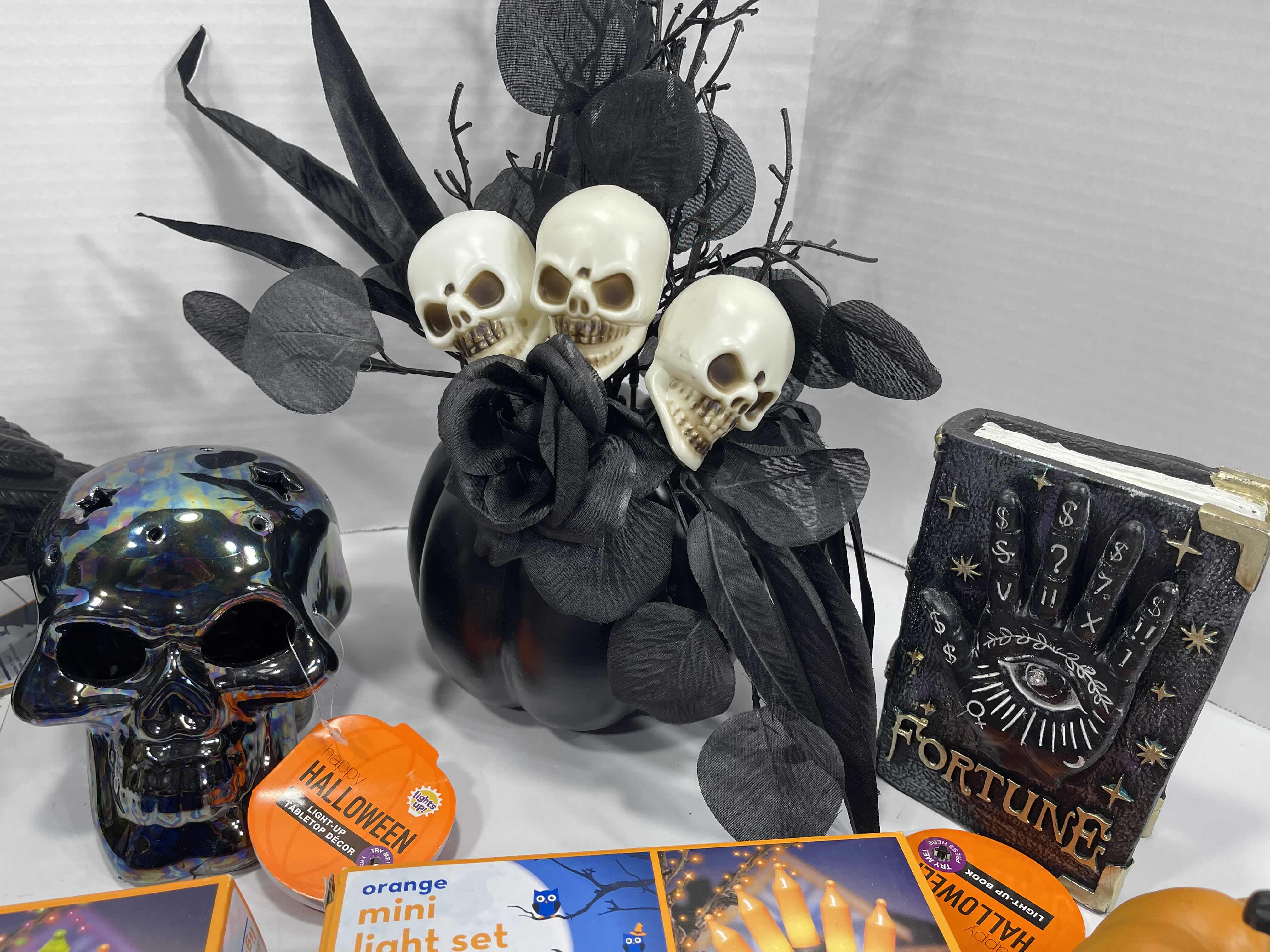Photo 1 of HALLOWEEN HOME TABLE TOP DECOR (14 ITEMS) -  SPIDER WEBS, LIGHT SETS, GLASS BOTTLE, RAVEN WATER-GLOBE, RESIN DECOR ETC MSRP $100