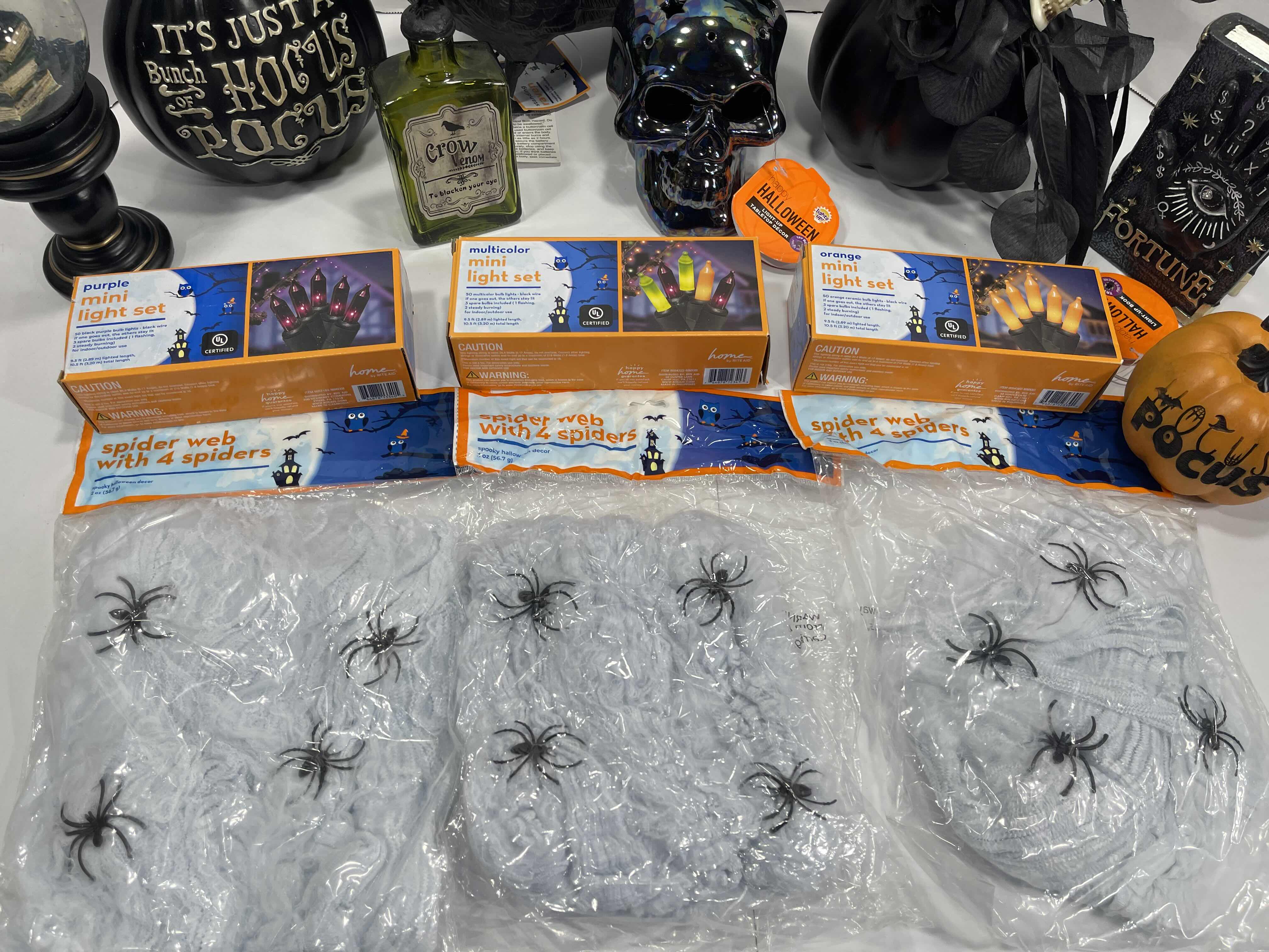Photo 1 of HALLOWEEN HOME TABLE TOP DECOR (14 ITEMS) -  SPIDER WEBS, LIGHT SETS, GLASS BOTTLE, RAVEN WATER-GLOBE, RESIN DECOR ETC MSRP $100