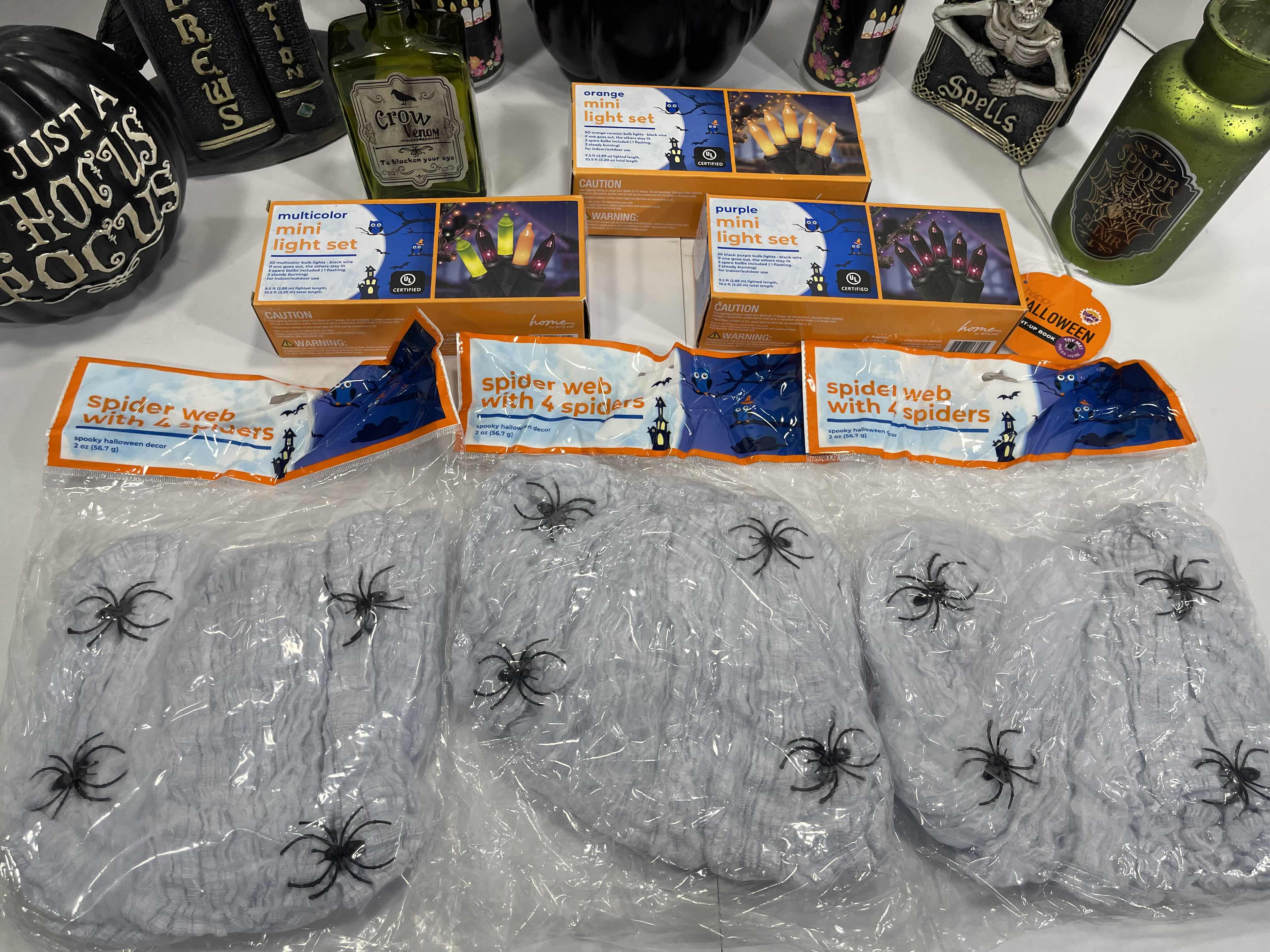 Photo 1 of HALLOWEEN HOME TABLE TOP DECOR (14 ITEMS) -  SPIDER WEBS, LIGHT SETS, CANDLES, RESIN DECOR ETC MSRP $100