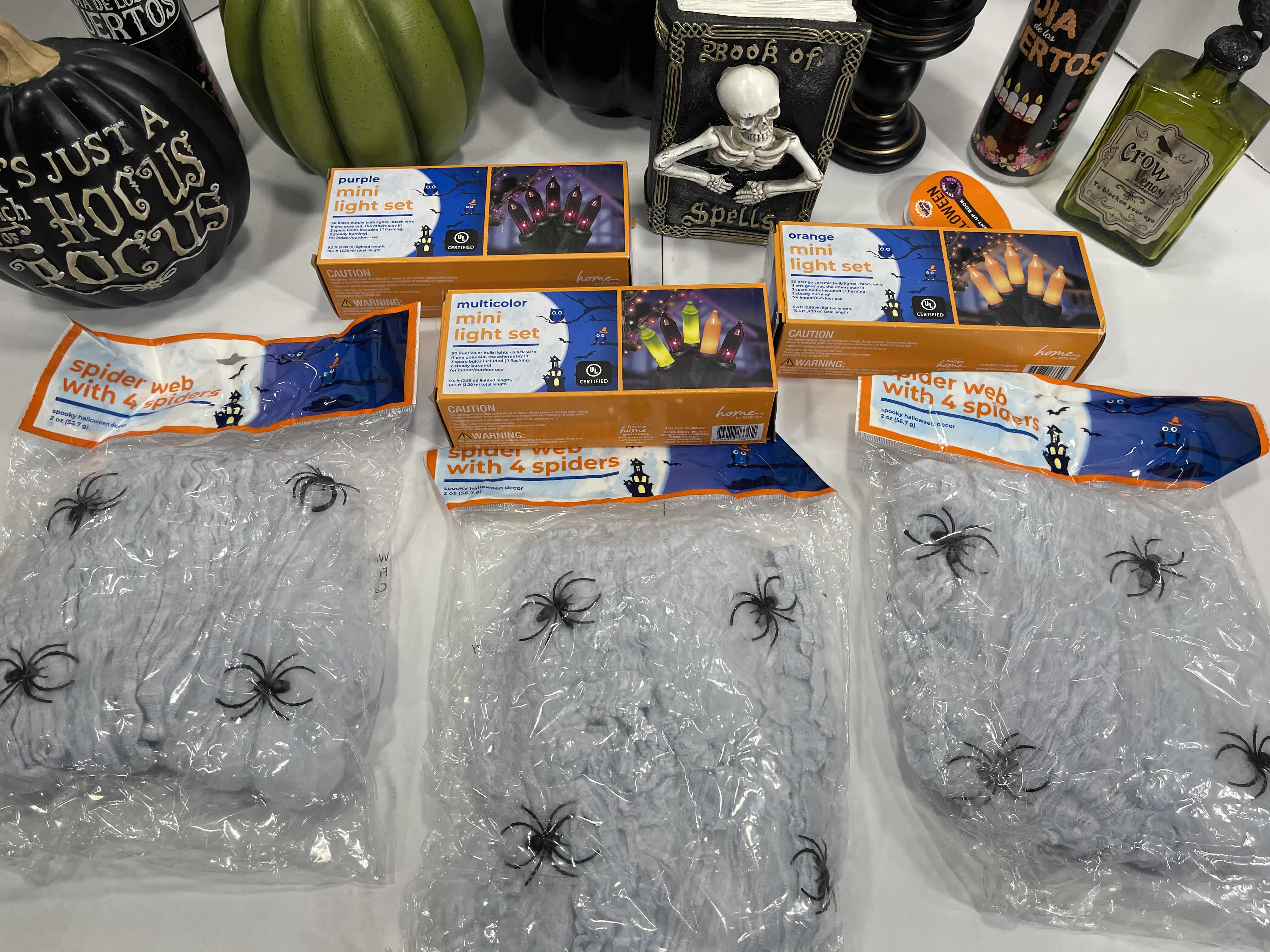 Photo 1 of HALLOWEEN HOME TABLE TOP DECOR (14 ITEMS) -  SPIDER WEBS, LIGHT SETS, GLASS BOTTLE, RAVEN WATER-GLOBE, RESIN DECOR ETC MSRP $100