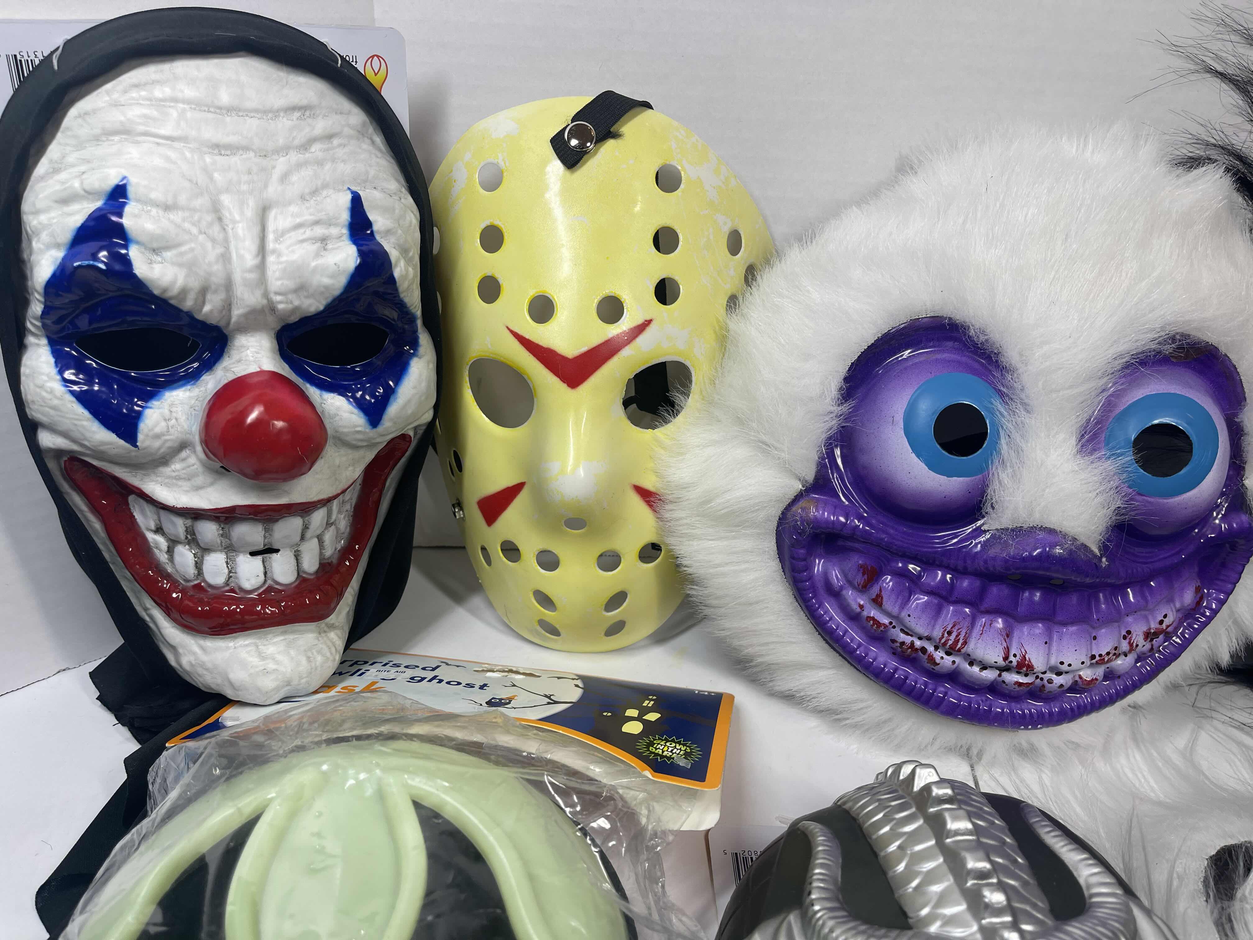Photo 1 of HALLOWEEN PLASTIC MASKS (8) ONE SIZE FITS MOST ADULTS
