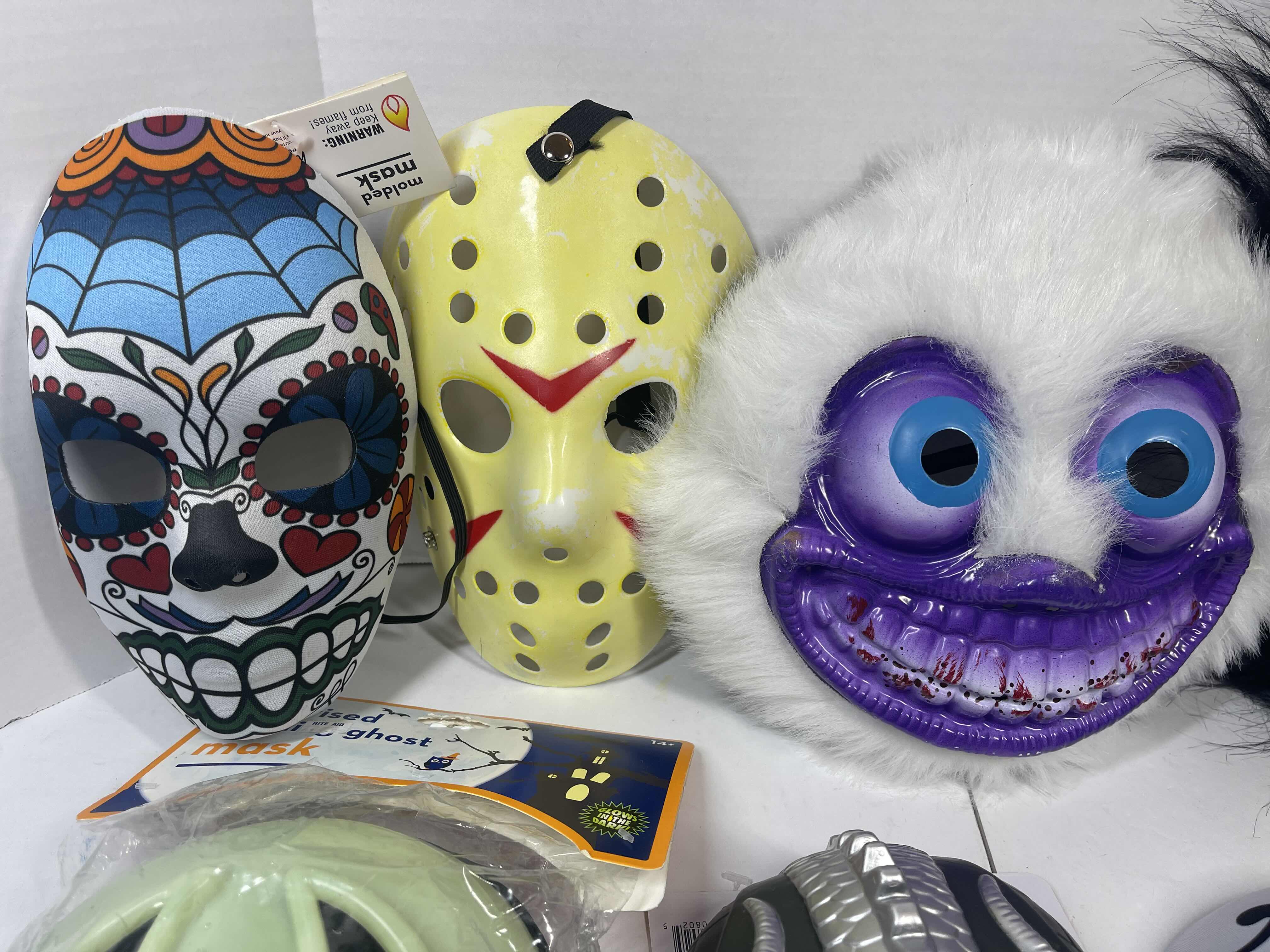 Photo 1 of HALLOWEEN PLASTIC MASKS (8) ONE SIZE FITS MOST ADULTS