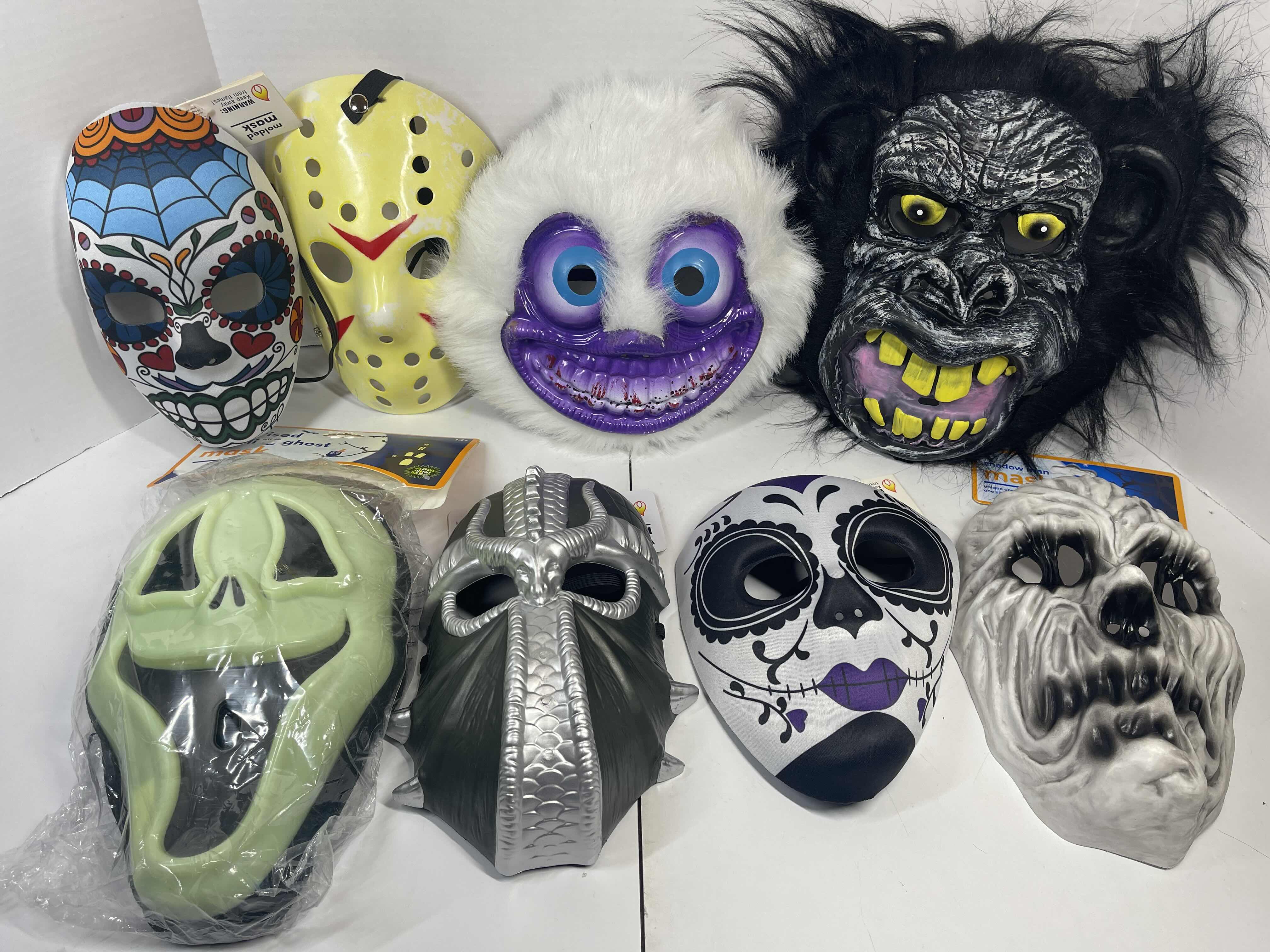 Photo 1 of HALLOWEEN PLASTIC MASKS (8) ONE SIZE FITS MOST ADULTS