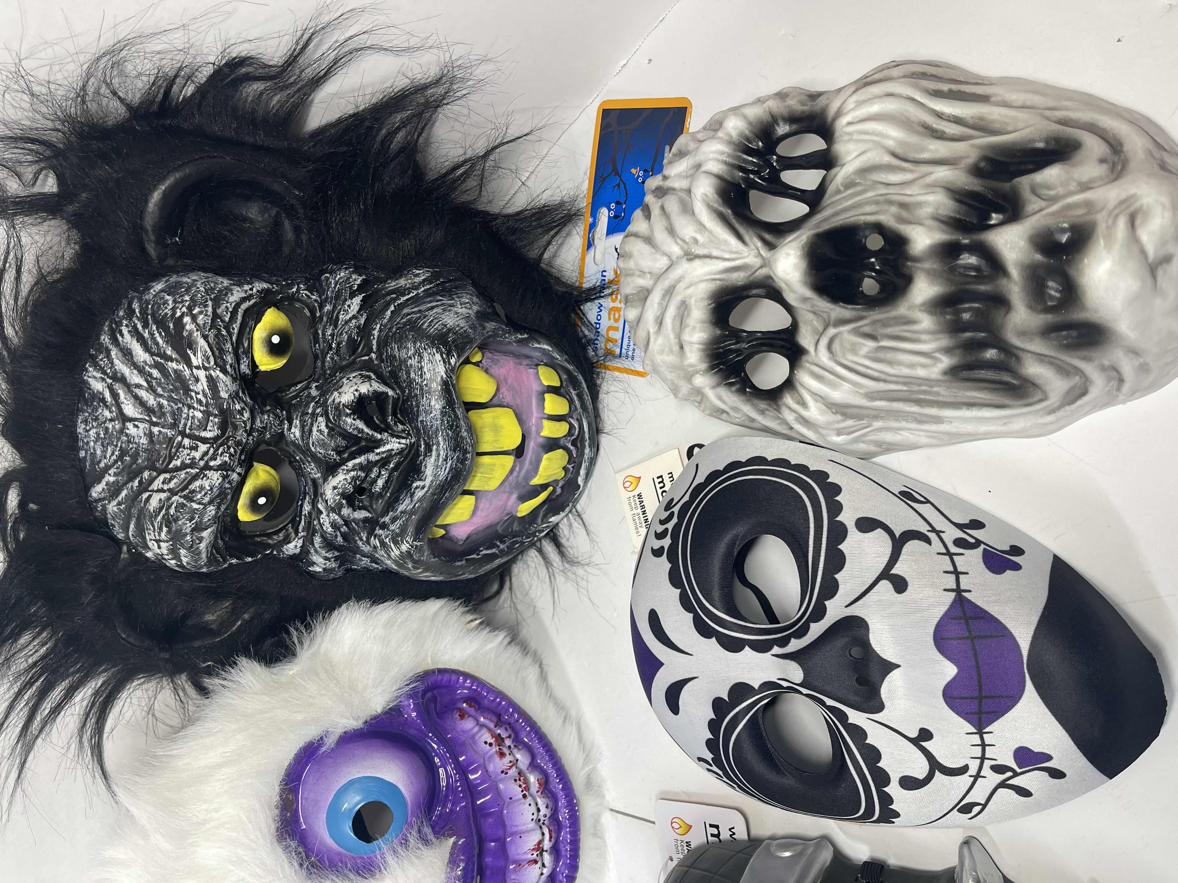 Photo 4 of HALLOWEEN PLASTIC MASKS (8) ONE SIZE FITS MOST ADULTS