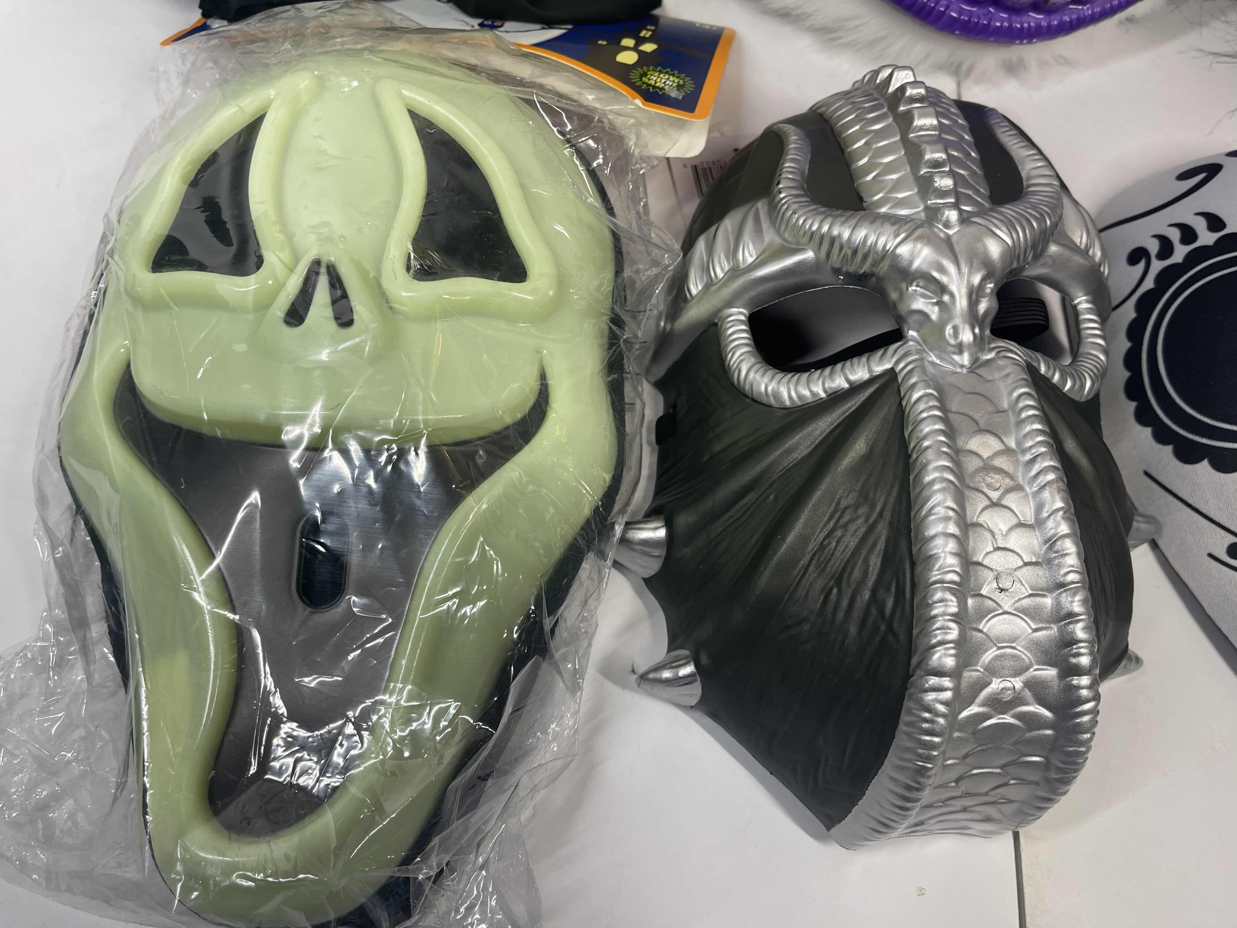 Photo 1 of HALLOWEEN PLASTIC MASKS (8) ONE SIZE FITS MOST ADULTS