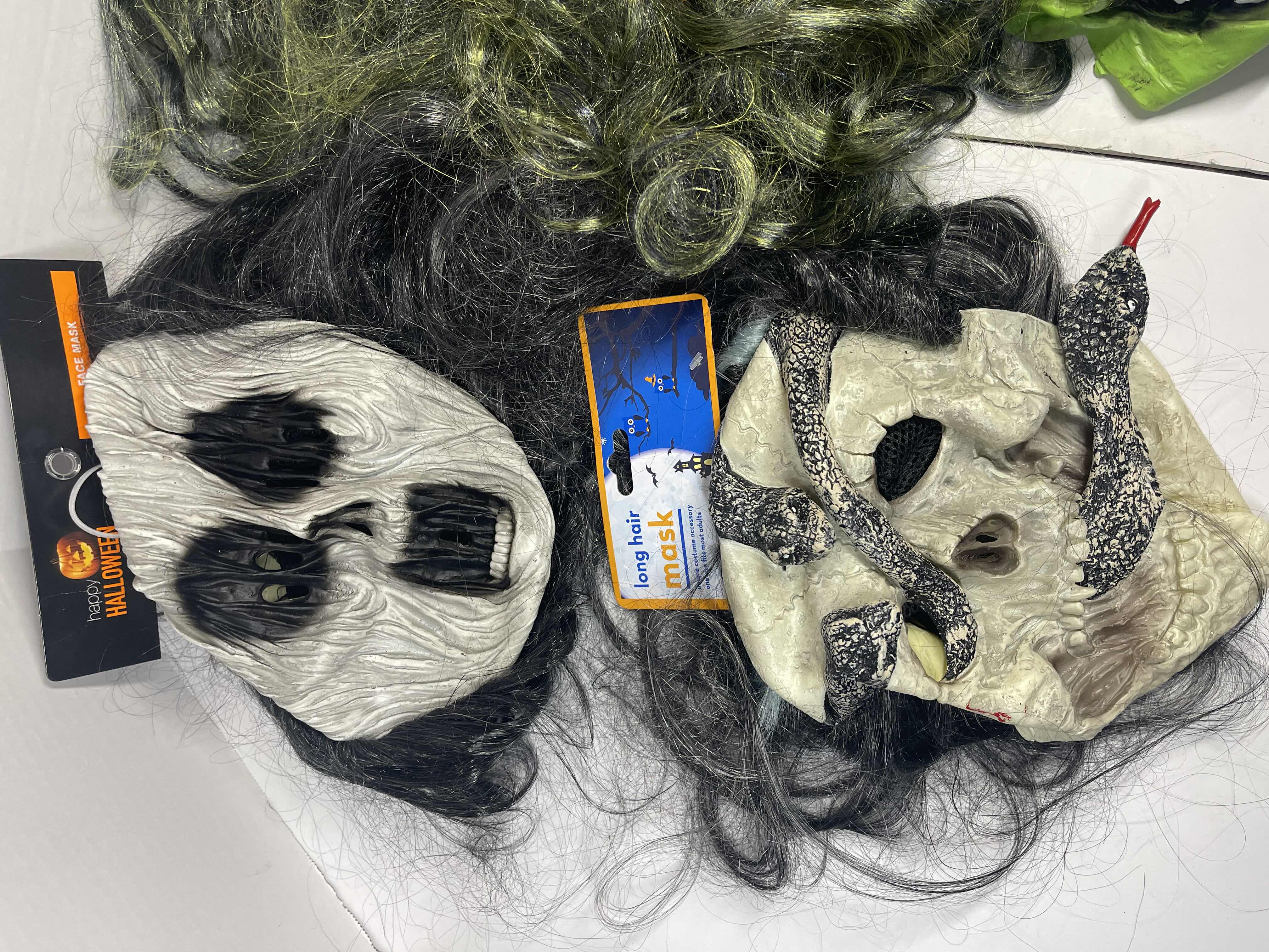 Photo 1 of HALLOWEEN RUBBER MASKS WITH HAIR (4) ONE SIZE FITS MOST ADULTS MSRP $65