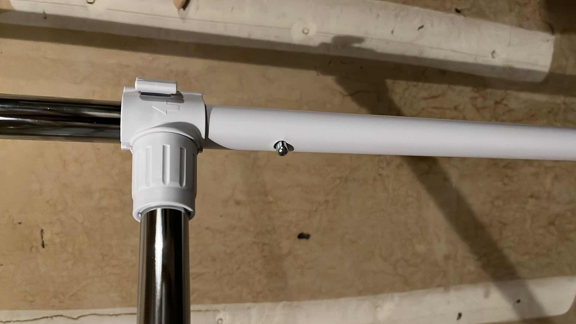 Photo 1 of WHITE & STAINLESS STEEL ROLLING 2 TIER CLOTHING RACK 36.5” X 65.5”