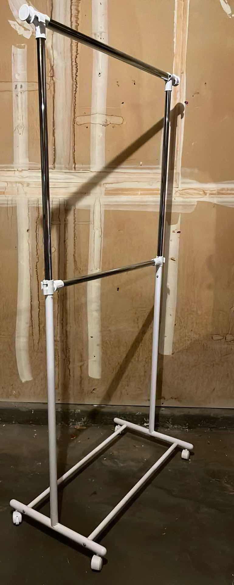 Photo 1 of WHITE & STAINLESS STEEL ROLLING 2 TIER CLOTHING RACK 36.5” X 65.5”