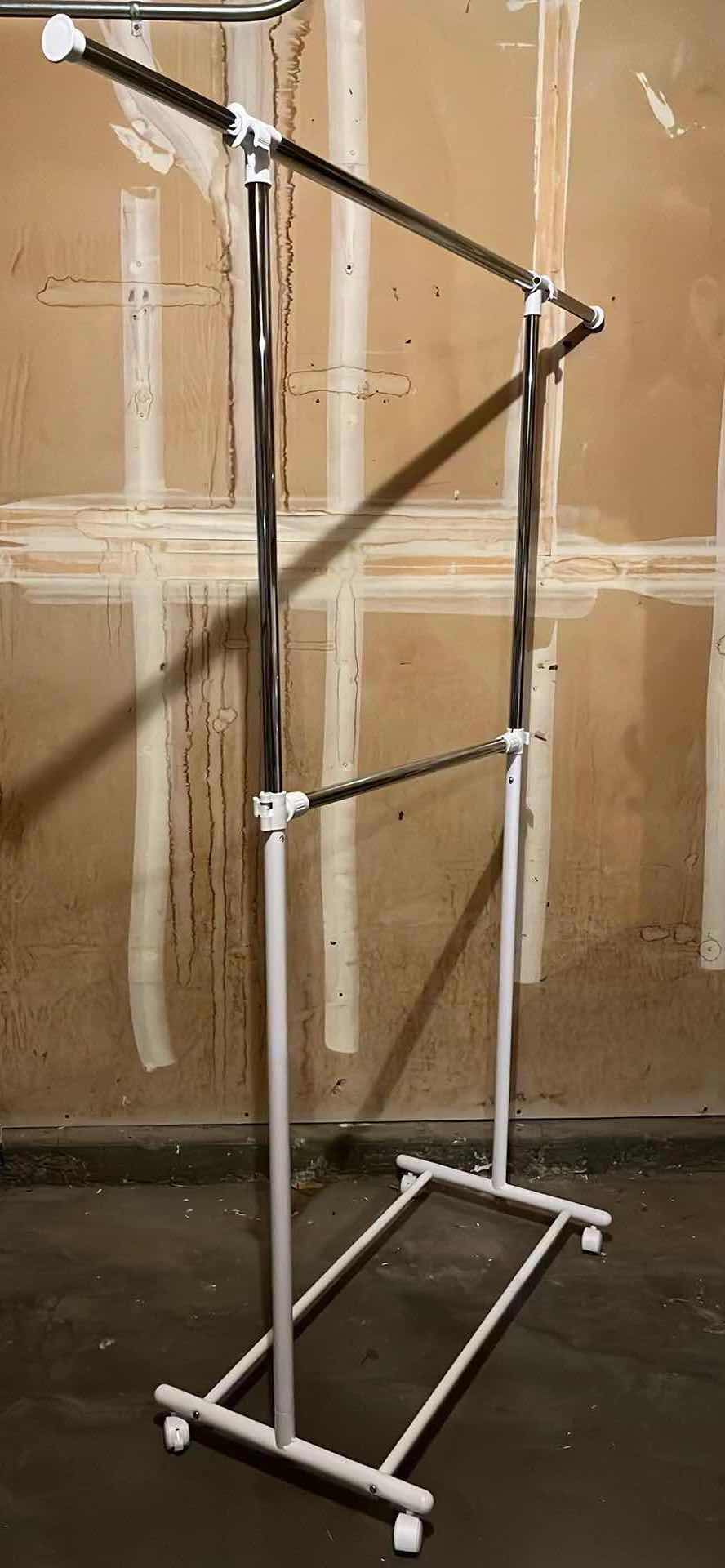 Photo 1 of WHITE & STAINLESS STEEL ROLLING 2 TIER CLOTHING RACK 36.5” X 65.5”