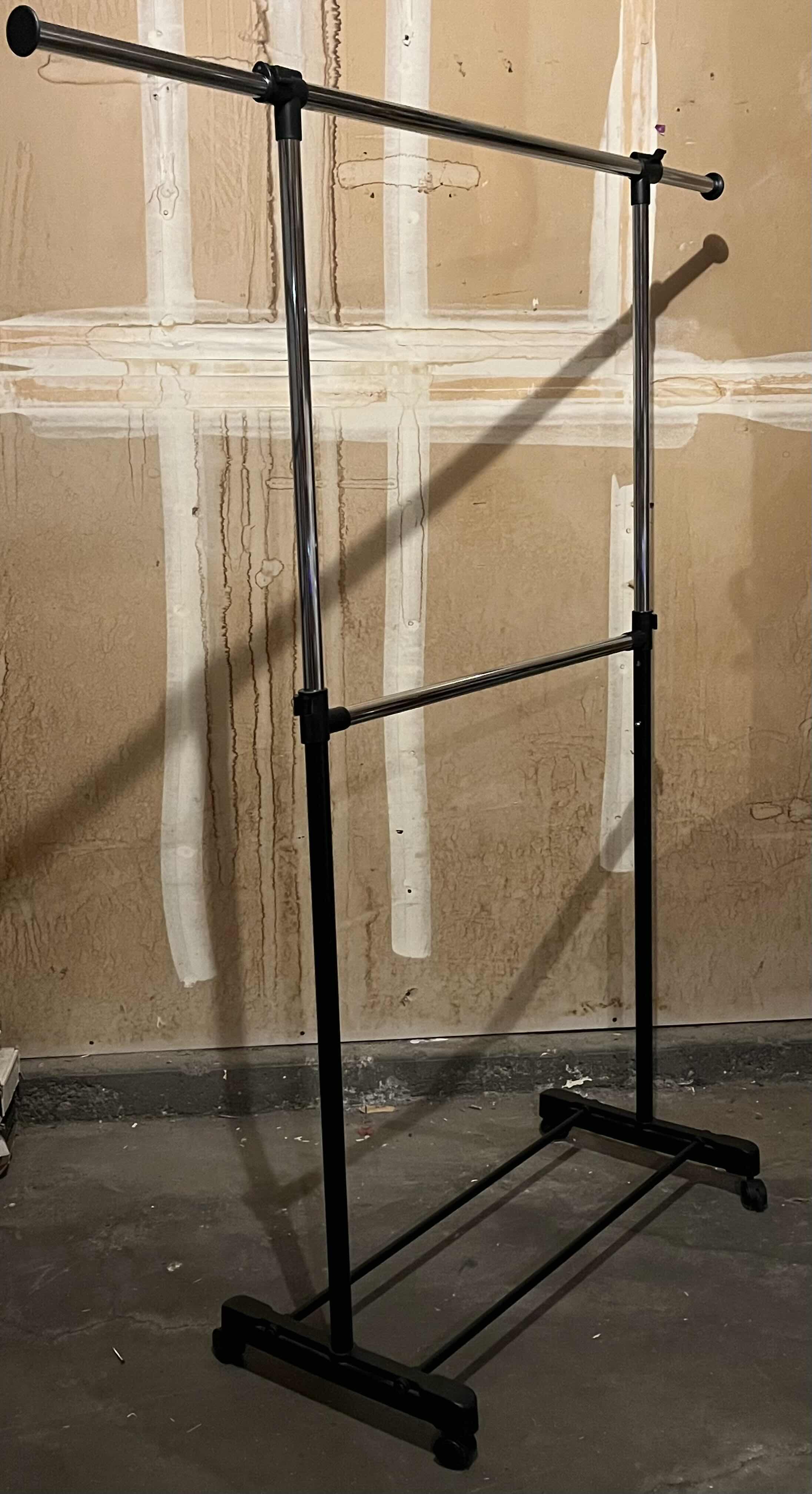 Photo 1 of BLACK & STAINLESS STEEL ROLLING ADJUSTABLE HEIGHT 2 TIER CLOTHING RACK 36.5” X 65.5”