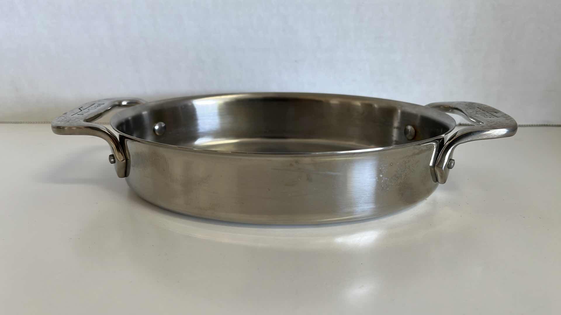 Photo 1 of ALL CLAD STAINLESS STEEL 2 HANDLE PAN 5.5” X 7” H1.5”