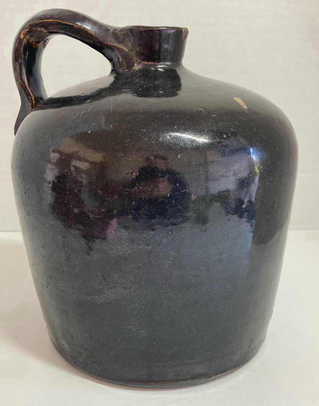 Photo 1 of ANTIQUE DARK BROWN STONEWARE WHISKEY JUG 8” X H9.5”