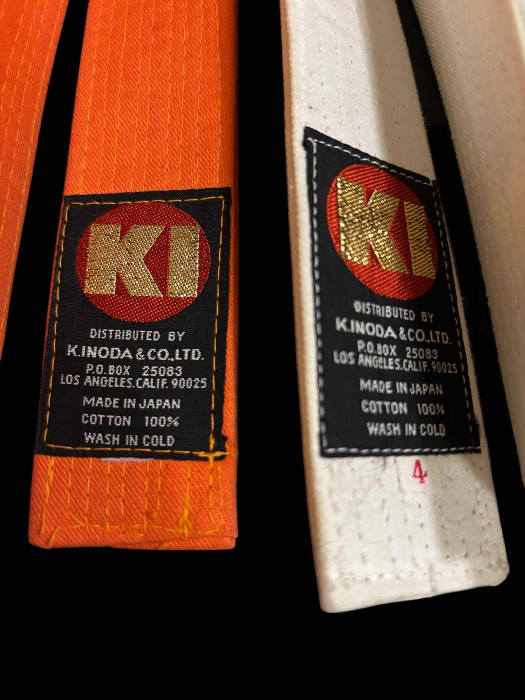 Photo 1 of KI DELUXE COLOR BELTS (2), ADULT SIZE 4, WHITE & ORANGE