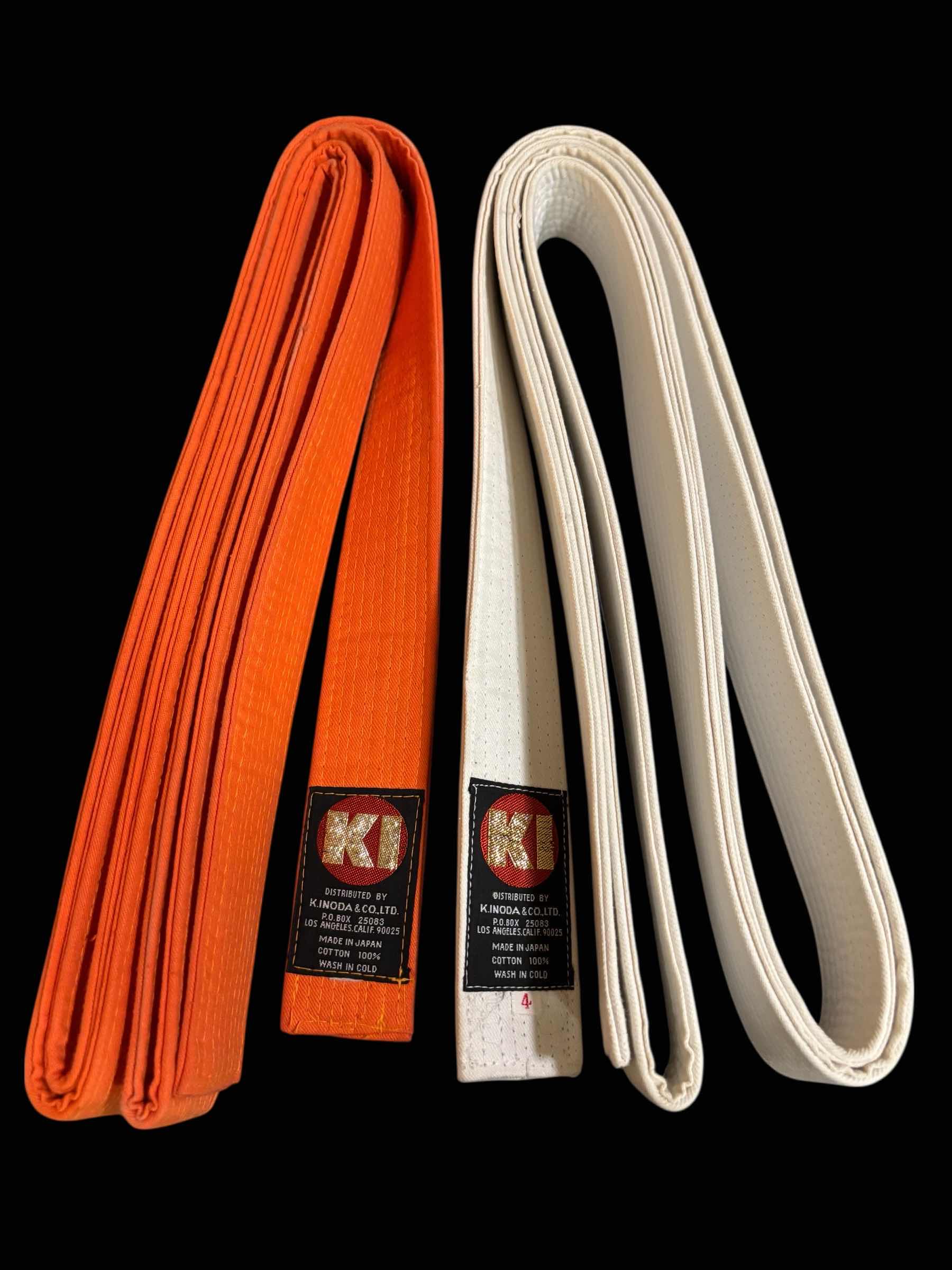 Photo 1 of KI DELUXE COLOR BELTS (2), ADULT SIZE 4, WHITE & ORANGE