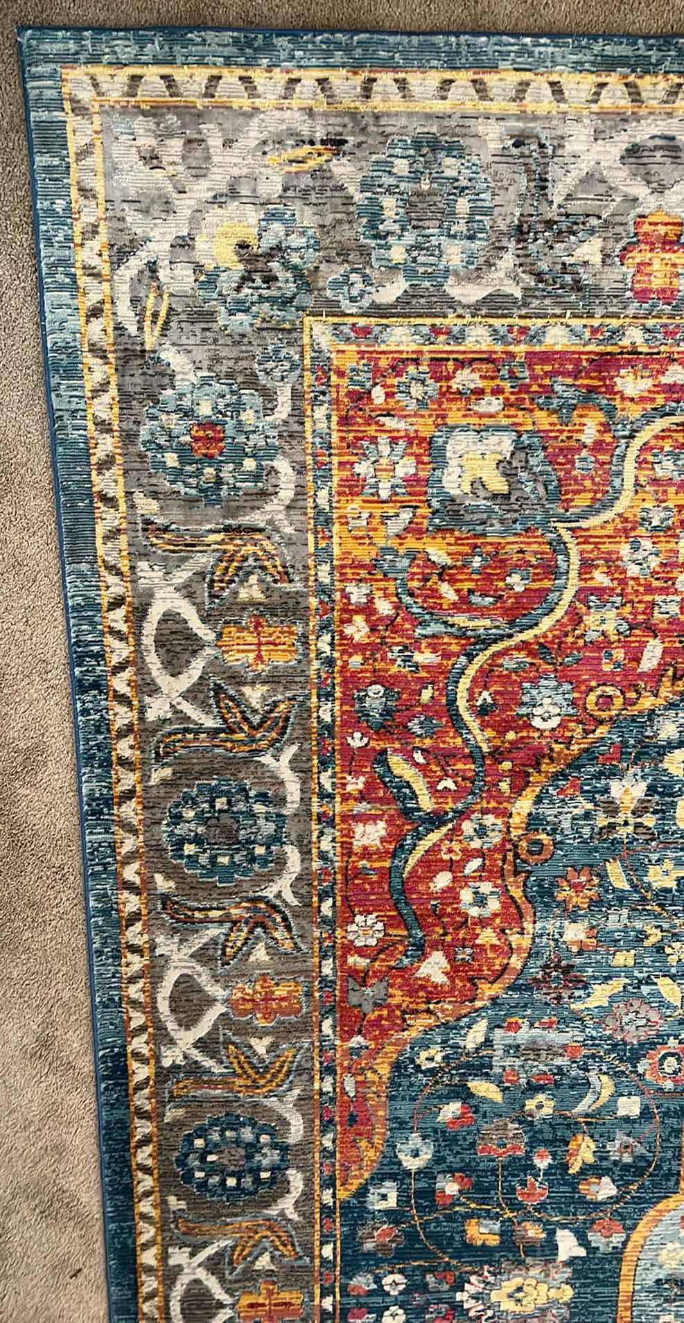 Photo 1 of 8’ x 12’ BLUE/RUST/CREAM MULTI-COLORED PATTERNED RUG.