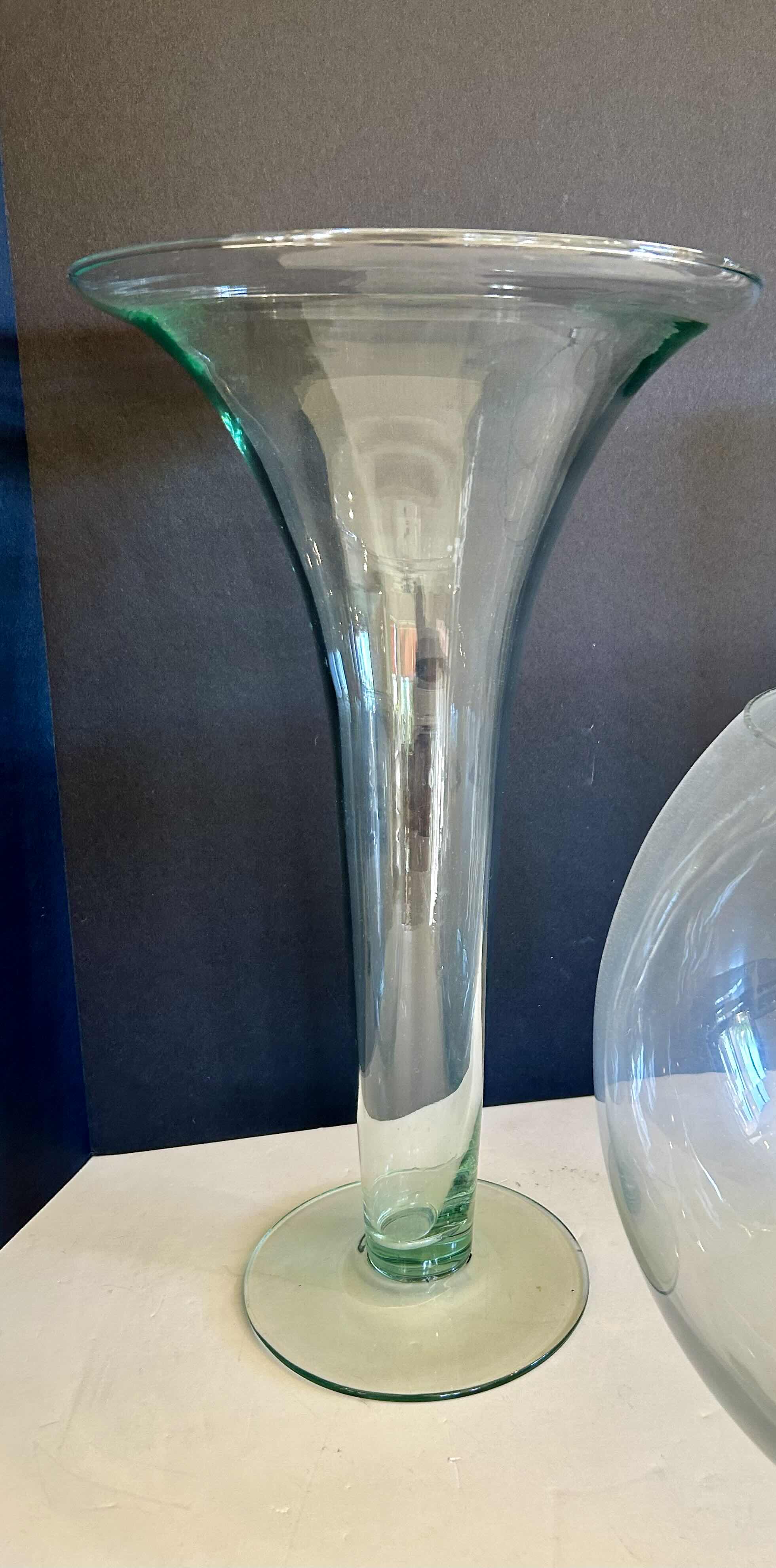 Photo 1 of 3 GLASS VASES (1) 10” H ROUND VASE, (1) FLUTED 14”H VASE, (1) SLENDER 14” H VASE