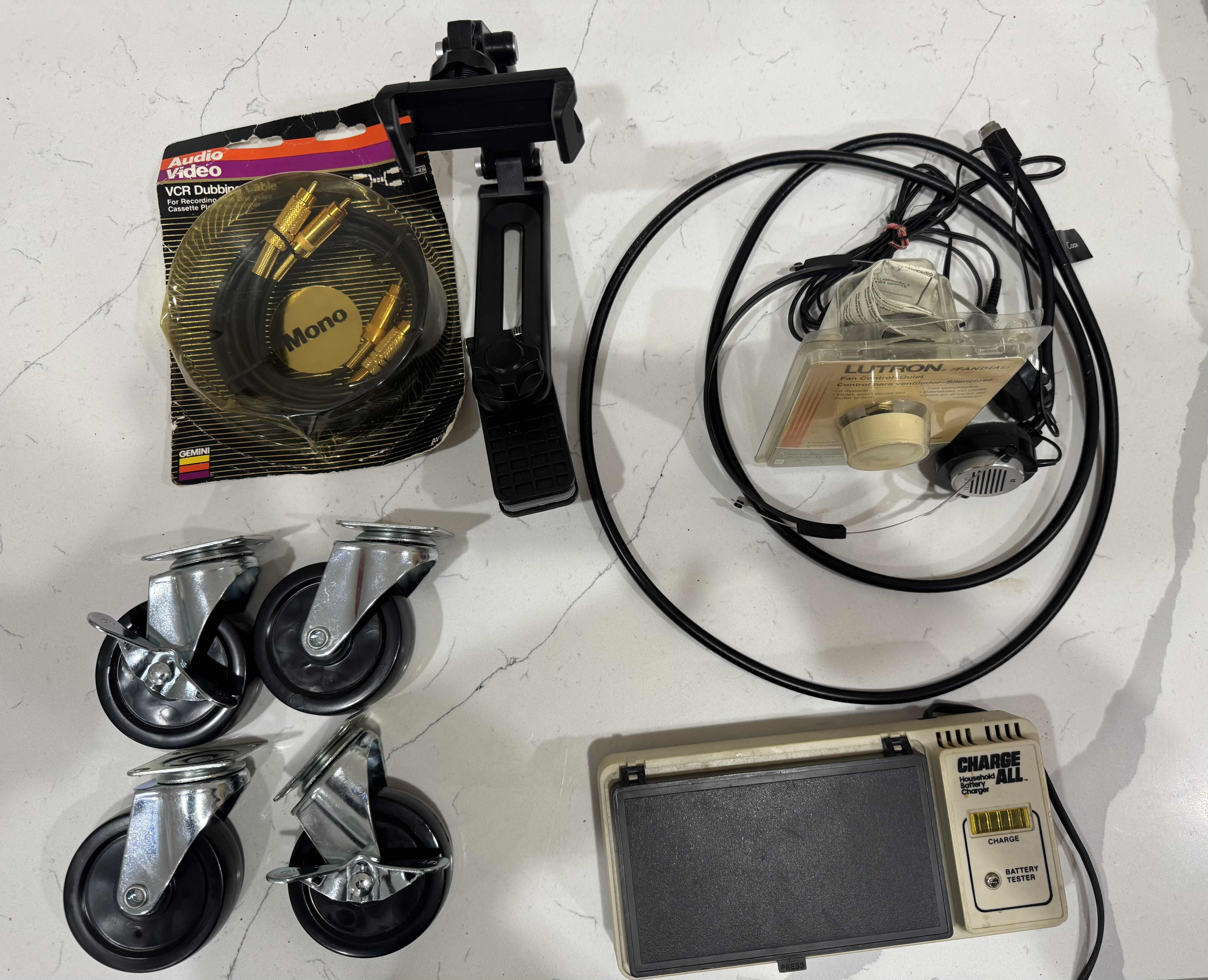 Photo 1 of ASSORTED HOME ITEMS, BATTERY TESTER, VCR  DUBBING CABLE, PHONE STAND, FAN CONTROL KNOB, VINTAGE HEAD PHONES