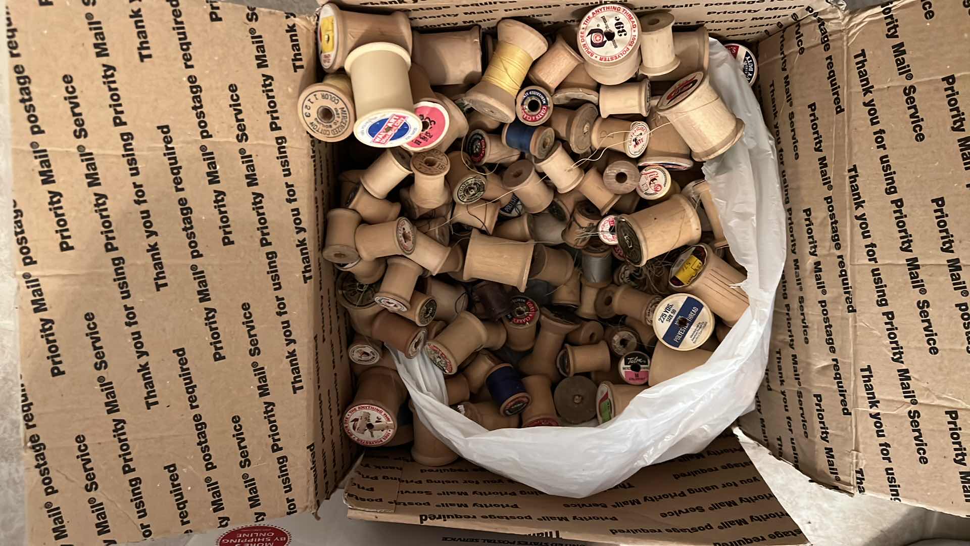 Photo 1 of BOX OF ANTIQUE WOODEN THREAD SPOOLS