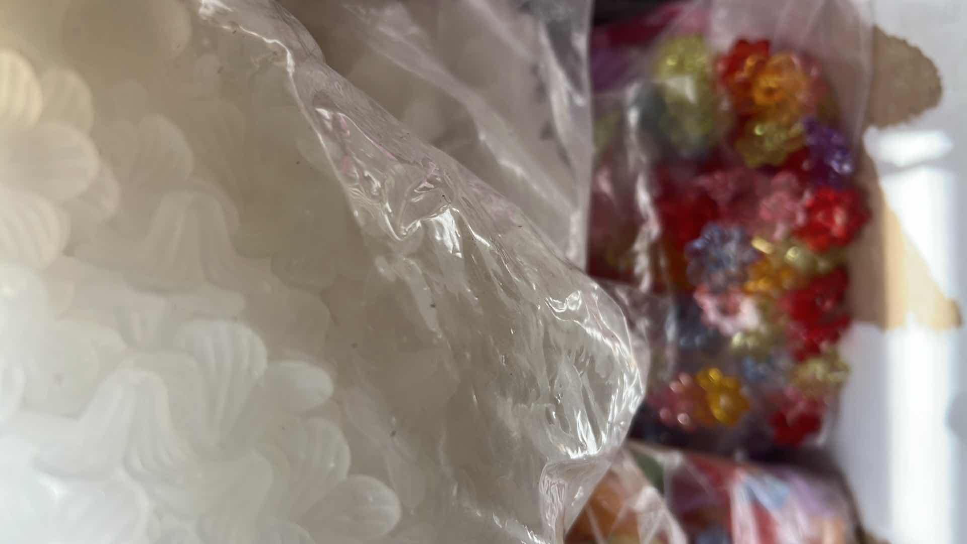 Photo 1 of BOX OF PLASTIC FLOWER BEADS AND BUTTONS