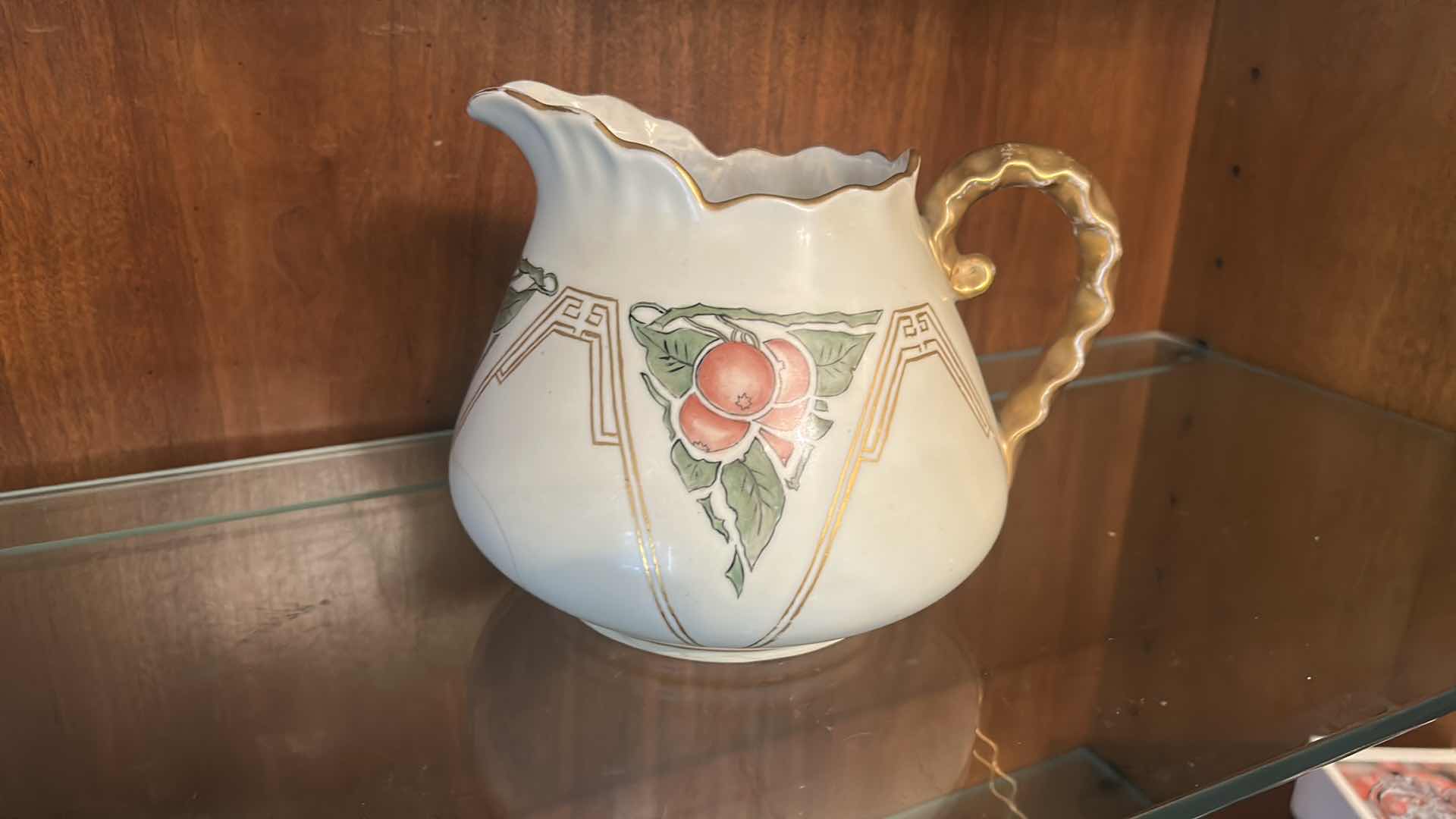 Photo 1 of ANTIQUE PORCELAIN WATER PITCHER OR CIDER JUG, LIKELY PRODUCED IN GERMANY OR FRANCE BETWEEN THE LATE 19TH AND EARLY 20TH CENTURY, FEATURING HAND-PAINTED RED CHERRY DESIGNS AND
