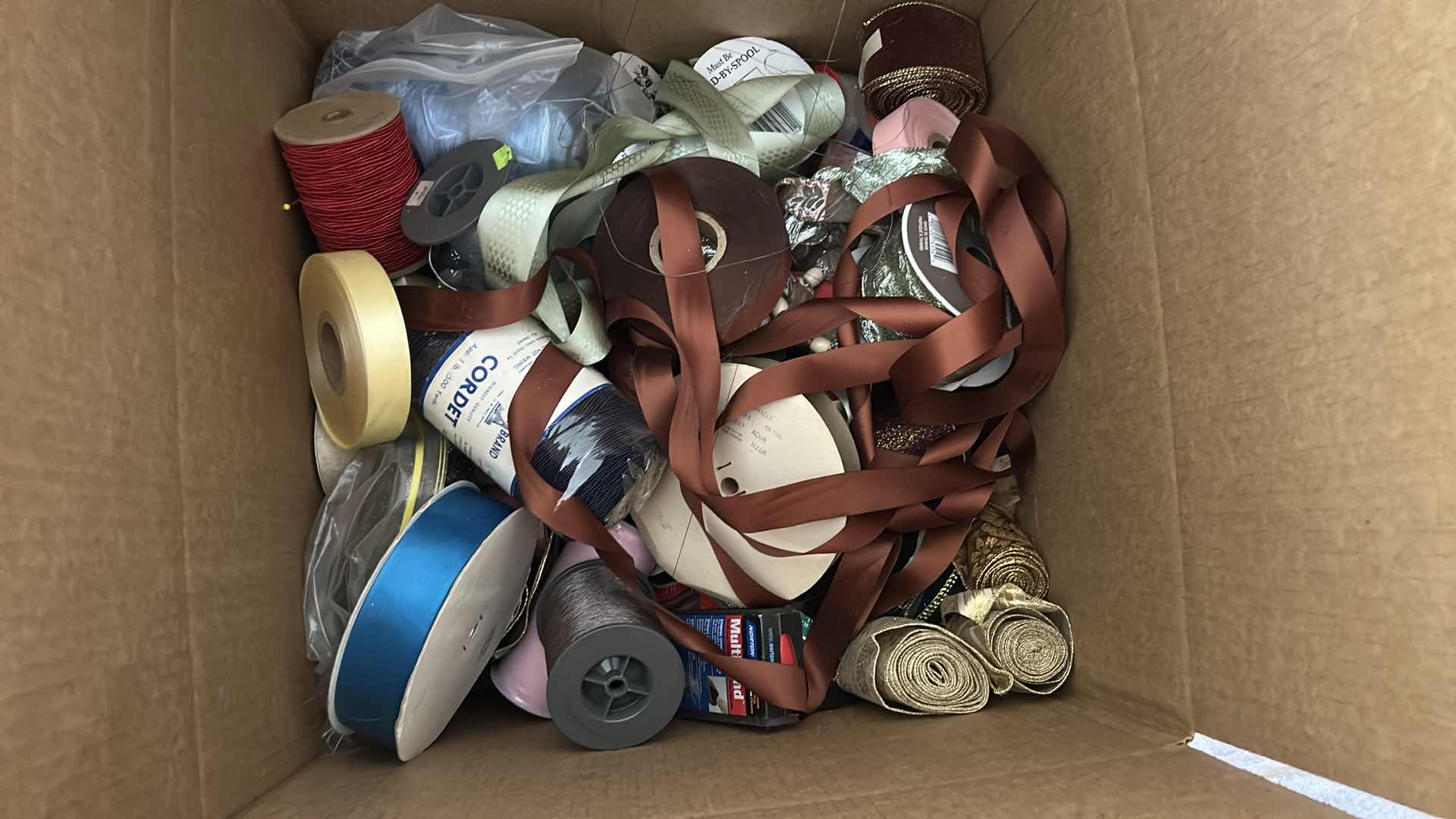 Photo 1 of CONTENTS OF BOX-RIBBON AND CORD.