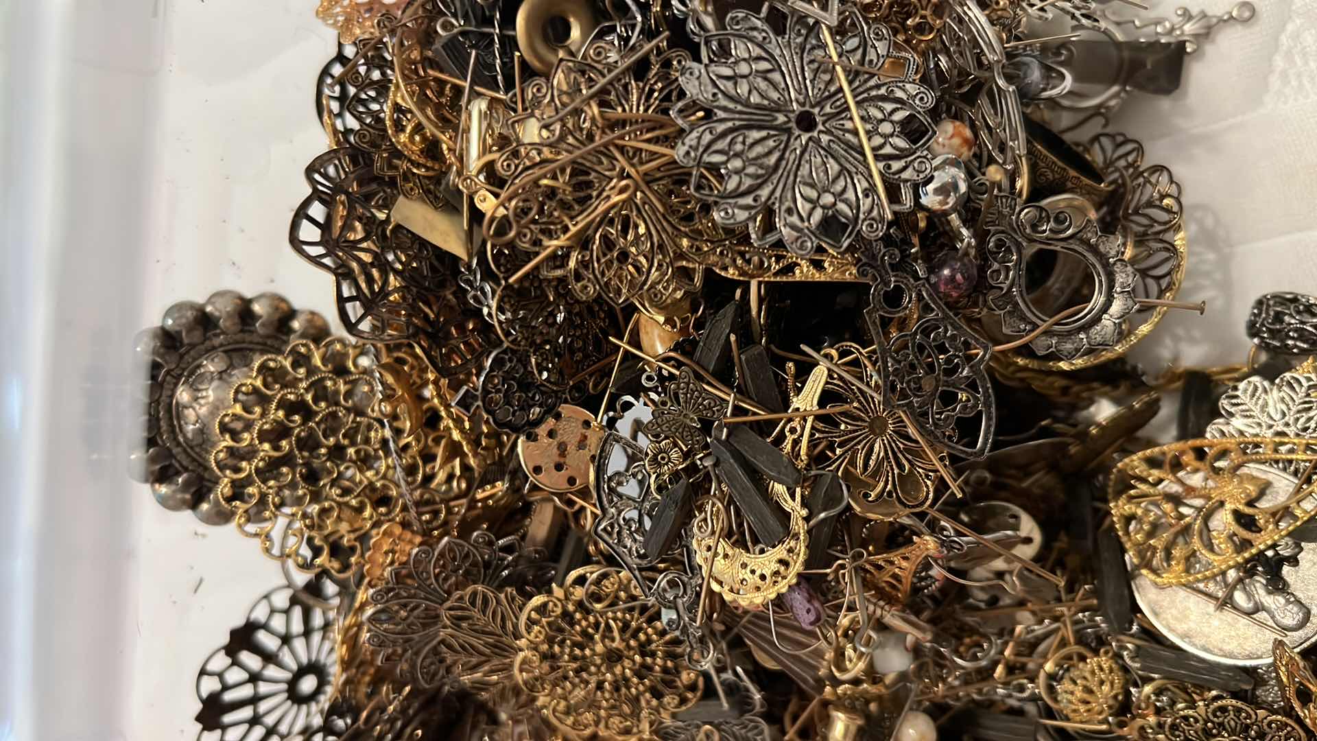 Photo 1 of PLASTIC BOX OF METAL JEWELRY MAKING EMBELLISHMENTS AND FINDINGS