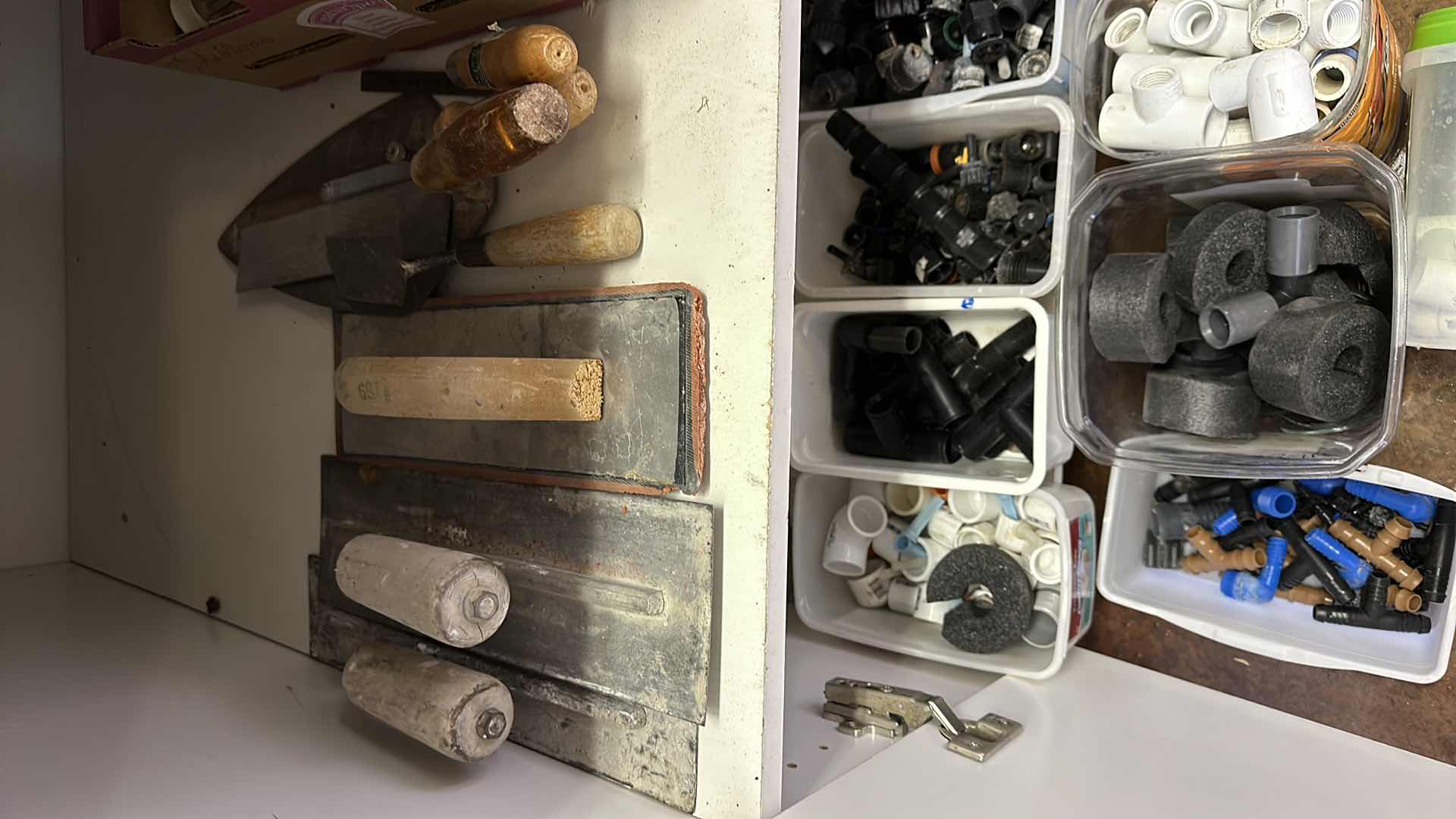 Photo 1 of CONTENTS OF CABINET PAINT ITEMS ,TILE TOOLS,IRRIGATION ITEMS