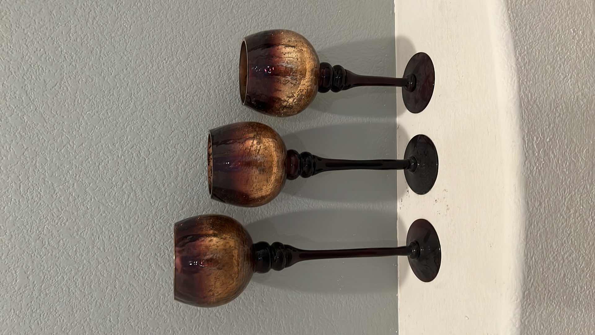 Photo 1 of 3-AMBER GLASS STEMMED CANDLEHOLDERS W CANDLES (H16",14",12")