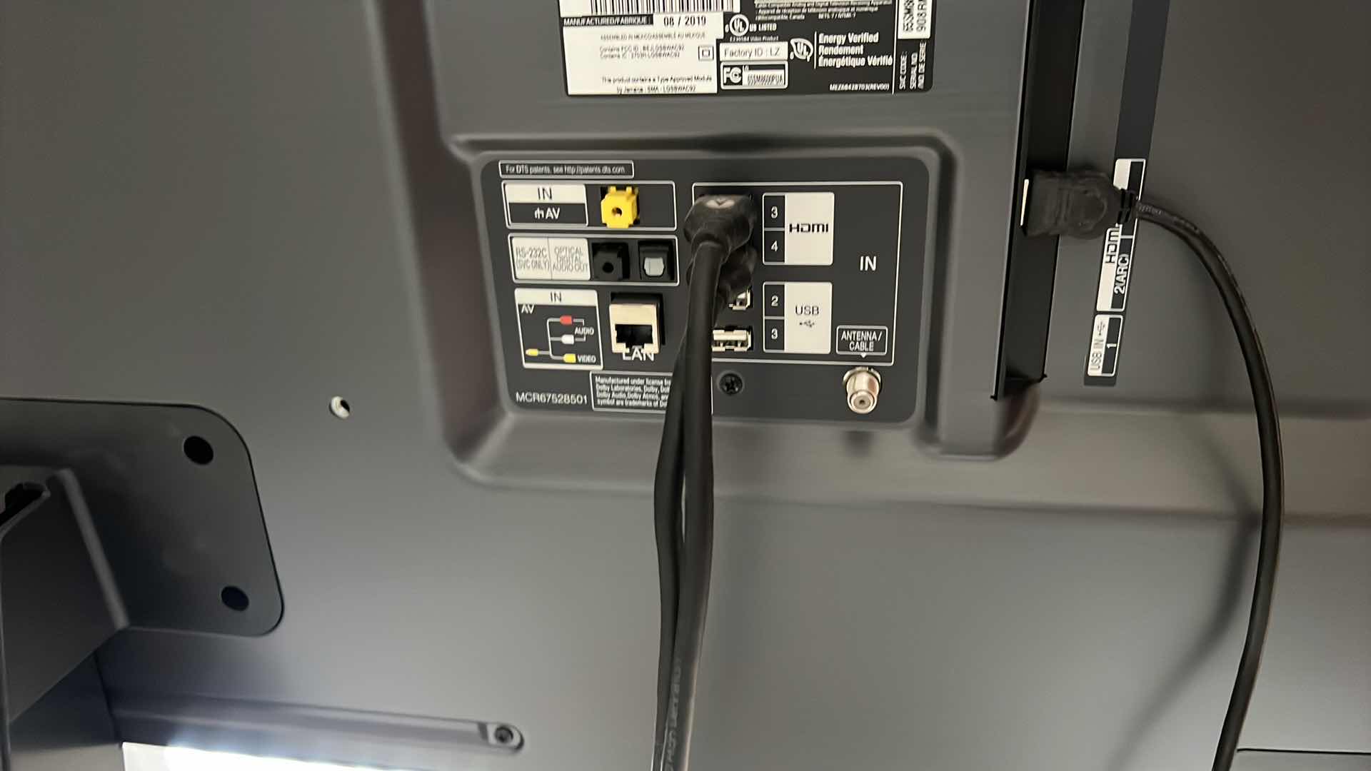 Photo 1 of 65" LG FLATSCREEN TV W REMOTE ON BLACK LAMINATE W GLASS ENTERTAINMENT CENTER