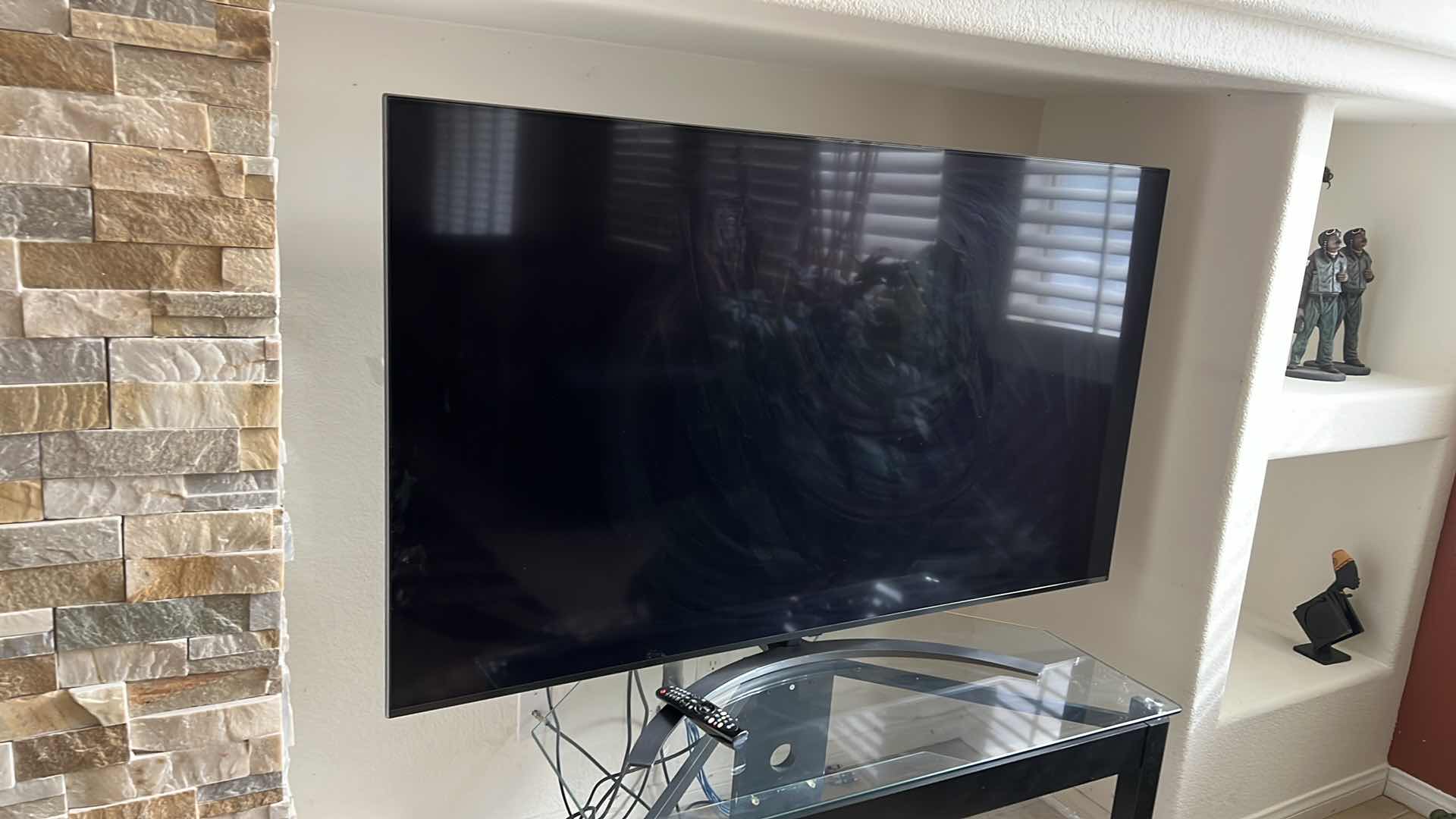 Photo 1 of 65" LG FLATSCREEN TV W REMOTE ON BLACK LAMINATE W GLASS ENTERTAINMENT CENTER