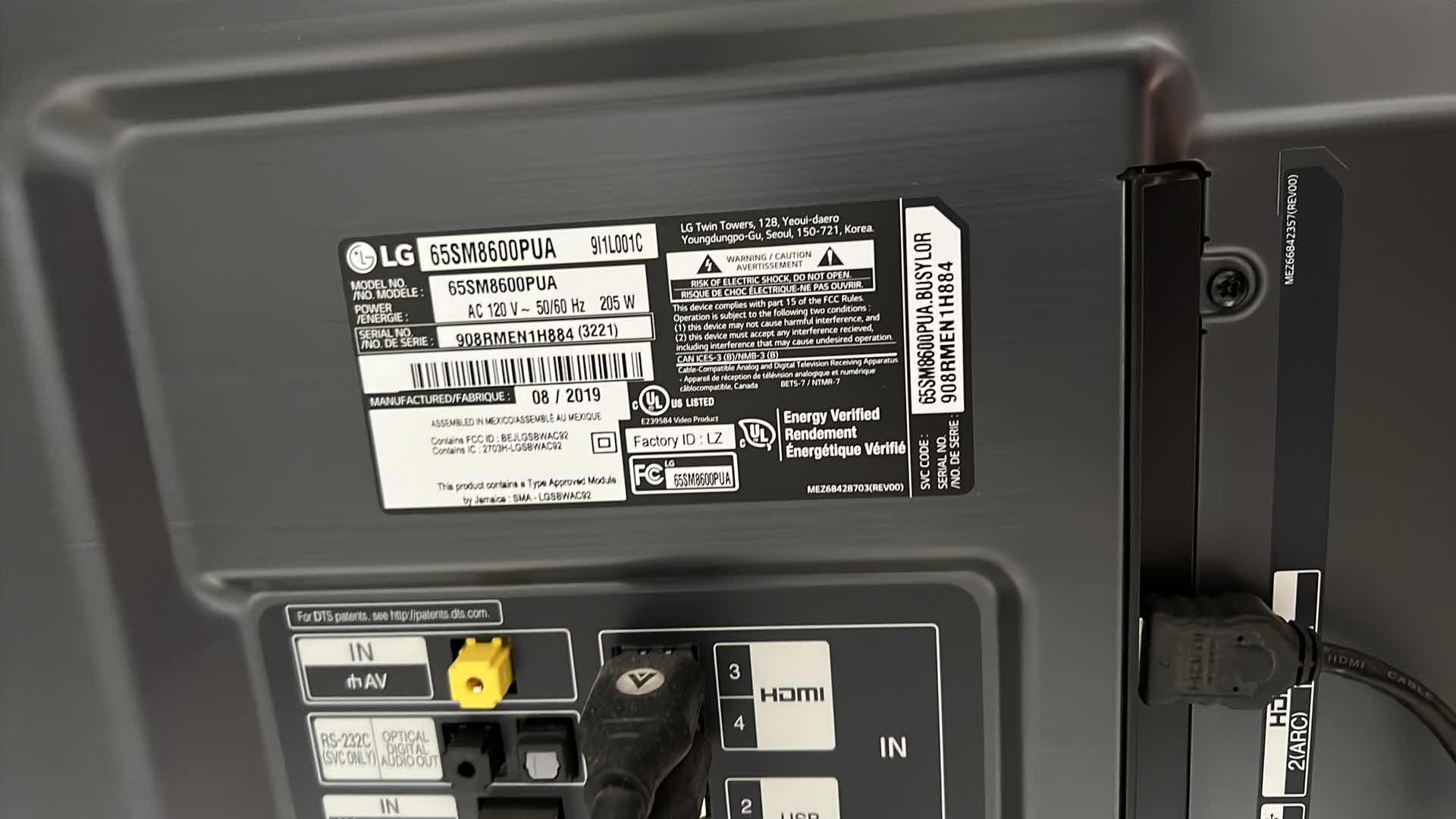 Photo 1 of 65" LG FLATSCREEN TV W REMOTE ON BLACK LAMINATE W GLASS ENTERTAINMENT CENTER