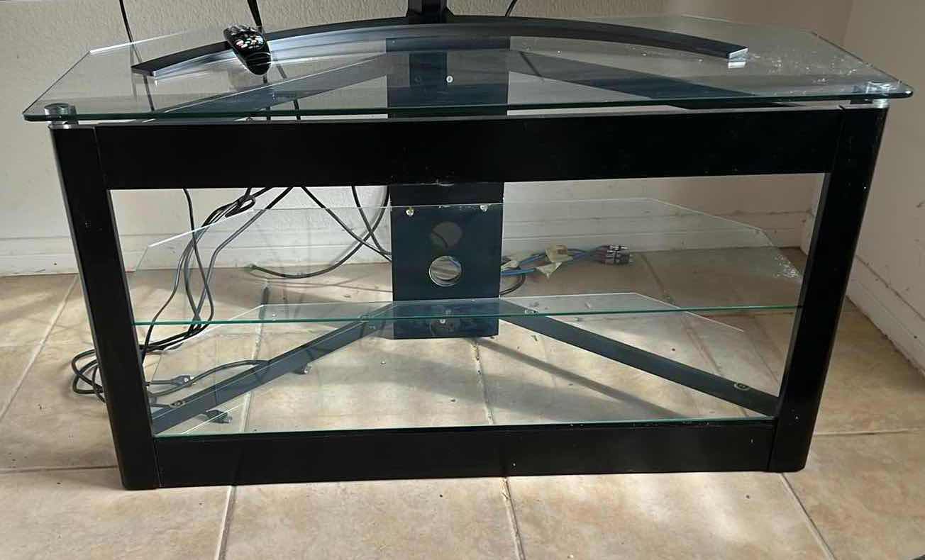 Photo 1 of 65" LG FLATSCREEN TV W REMOTE ON BLACK LAMINATE W GLASS ENTERTAINMENT CENTER