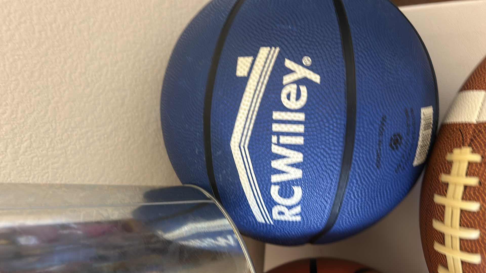Photo 1 of 2 BASKETBALLS, FOOTBALL AND RAIDERS BUCKET