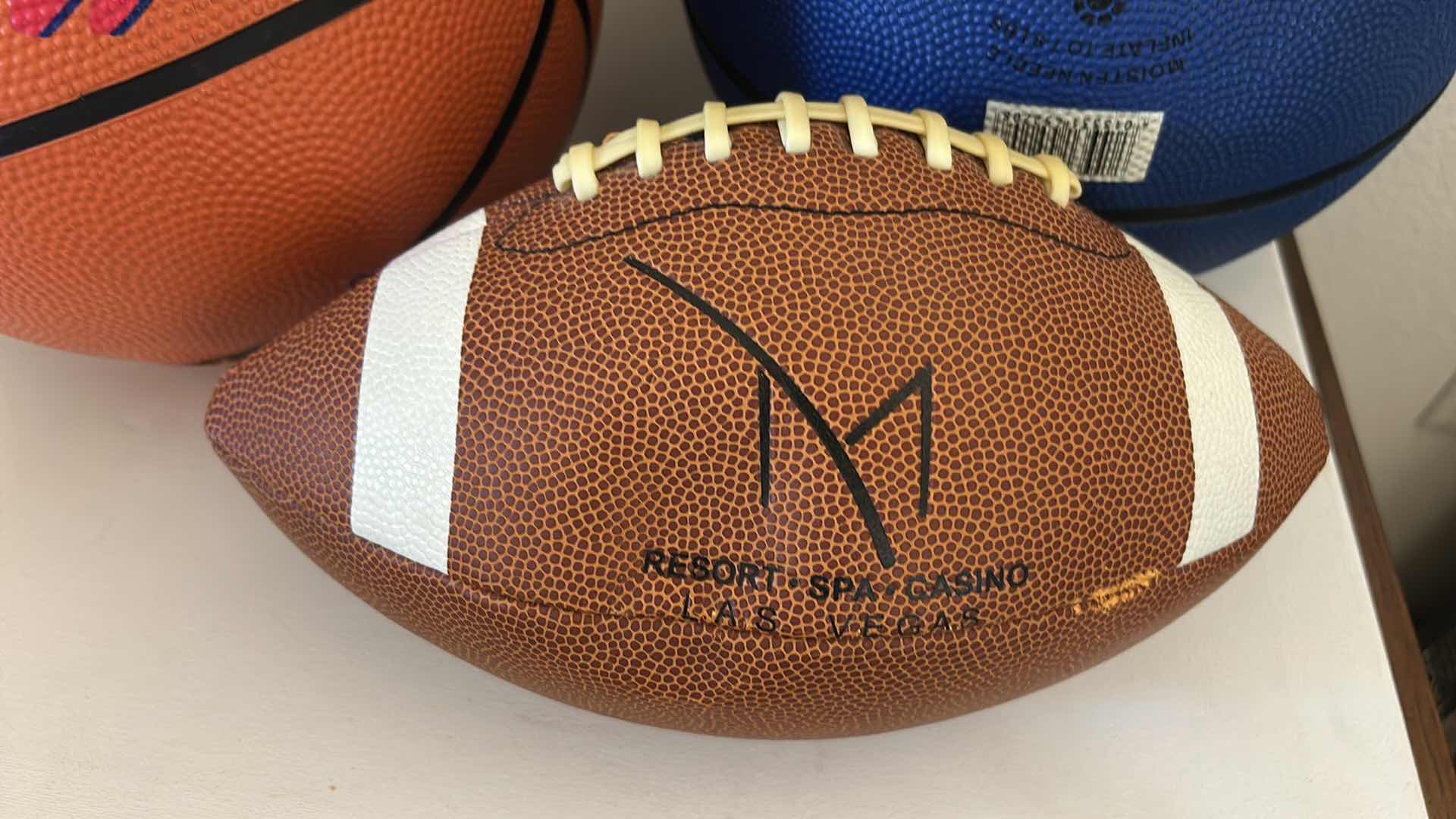 Photo 1 of 2 BASKETBALLS, FOOTBALL AND RAIDERS BUCKET