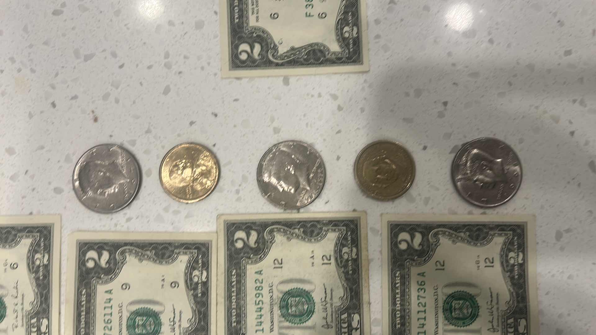 Photo 1 of US CURRENCY- 9 $2 BILLS, 3 KENNEDY HALF DOLLARS, GEORGE WASHINGTON $1 GOLD COIN & WAMPAMGAG TREATY GOLD $1 COIN