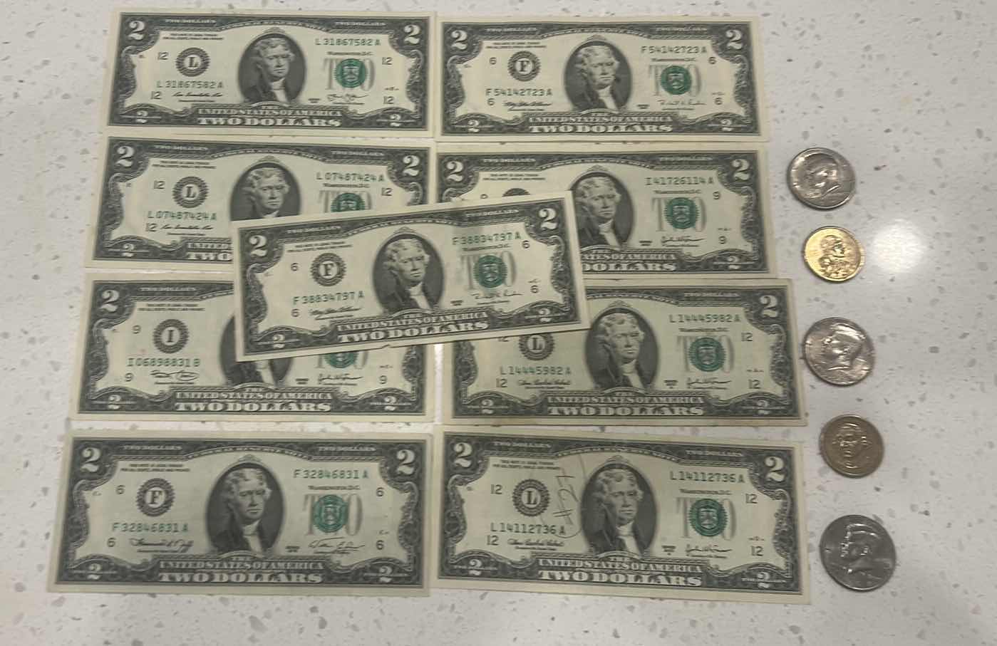 Photo 1 of US CURRENCY- 9 $2 BILLS, 3 KENNEDY HALF DOLLARS, GEORGE WASHINGTON $1 GOLD COIN & WAMPAMGAG TREATY GOLD $1 COIN