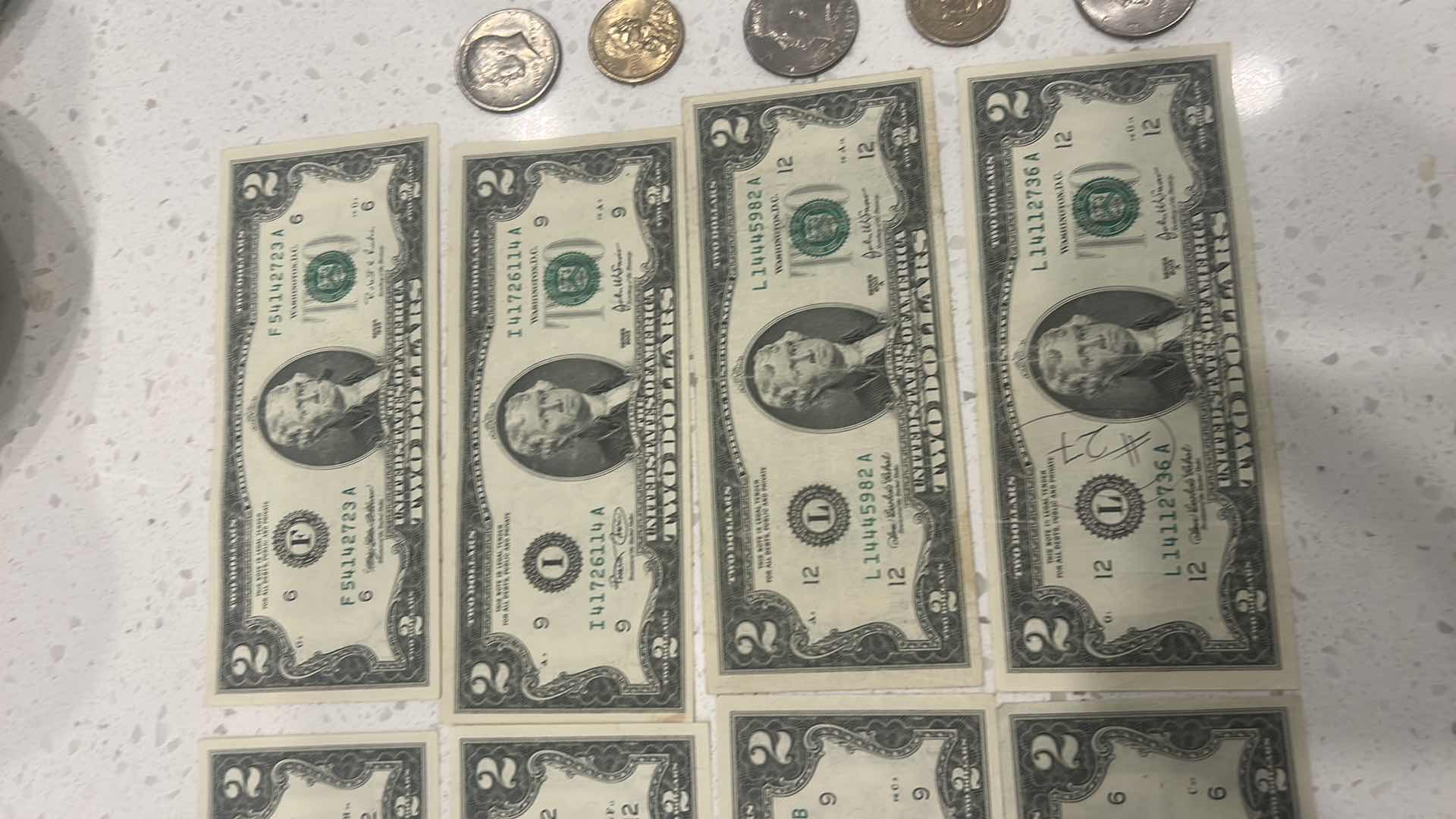 Photo 1 of US CURRENCY- 9 $2 BILLS, 3 KENNEDY HALF DOLLARS, GEORGE WASHINGTON $1 GOLD COIN & WAMPAMGAG TREATY GOLD $1 COIN