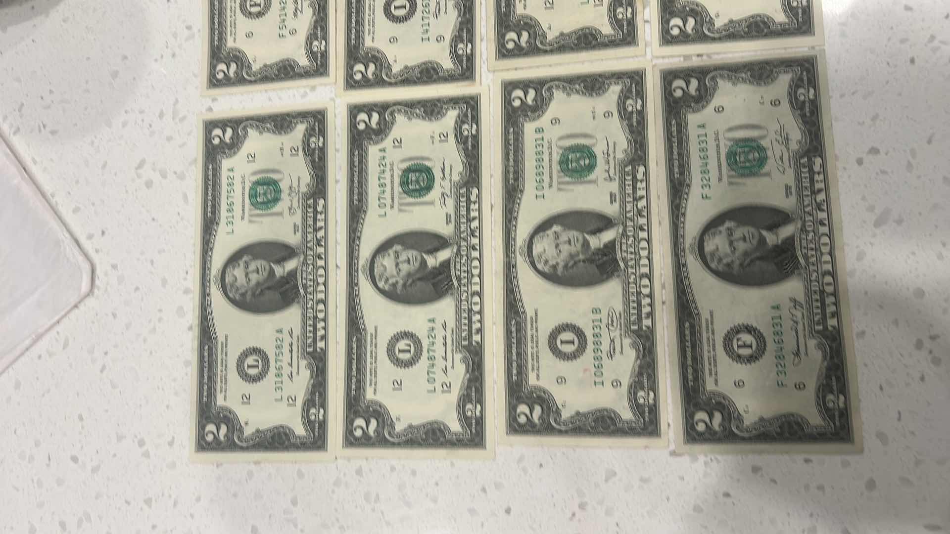 Photo 1 of US CURRENCY- 9 $2 BILLS, 3 KENNEDY HALF DOLLARS, GEORGE WASHINGTON $1 GOLD COIN & WAMPAMGAG TREATY GOLD $1 COIN