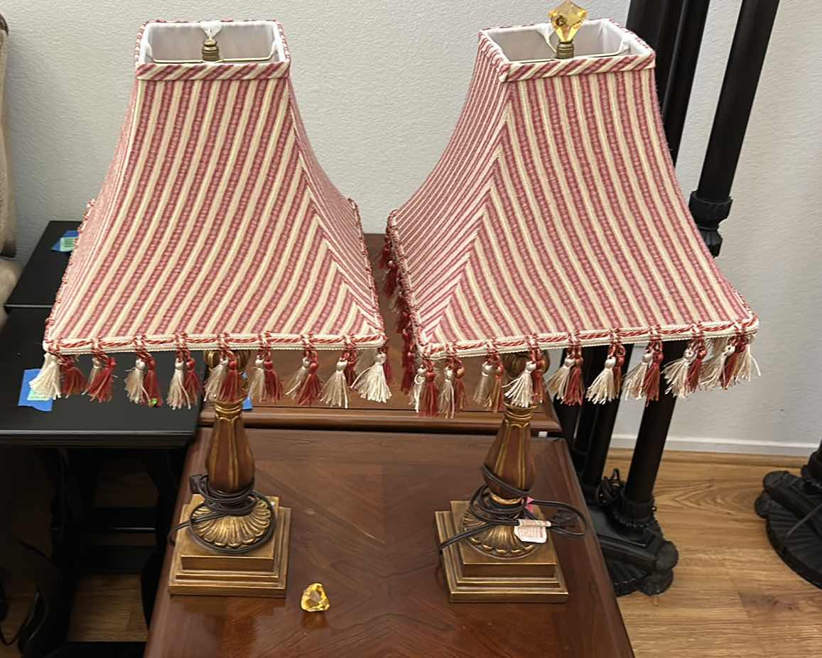 Photo 1 of 2 ANTIQUE GOLD COLORED TABLE LAMPS WITH RED AND IVORY FABRIC SHADES WITH TASSELS H26”