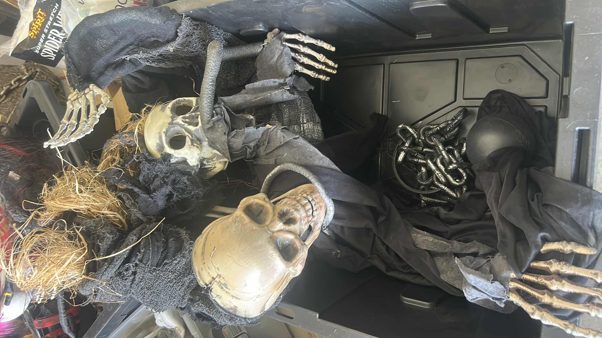 Photo 1 of HALLOWEEN DECORATIONS -TOTE WITH 2 LIFE SIZE SKELETONS, BALL AND CHAIN, GLASS BOTTLE SKELETON AND BABY BUGGY